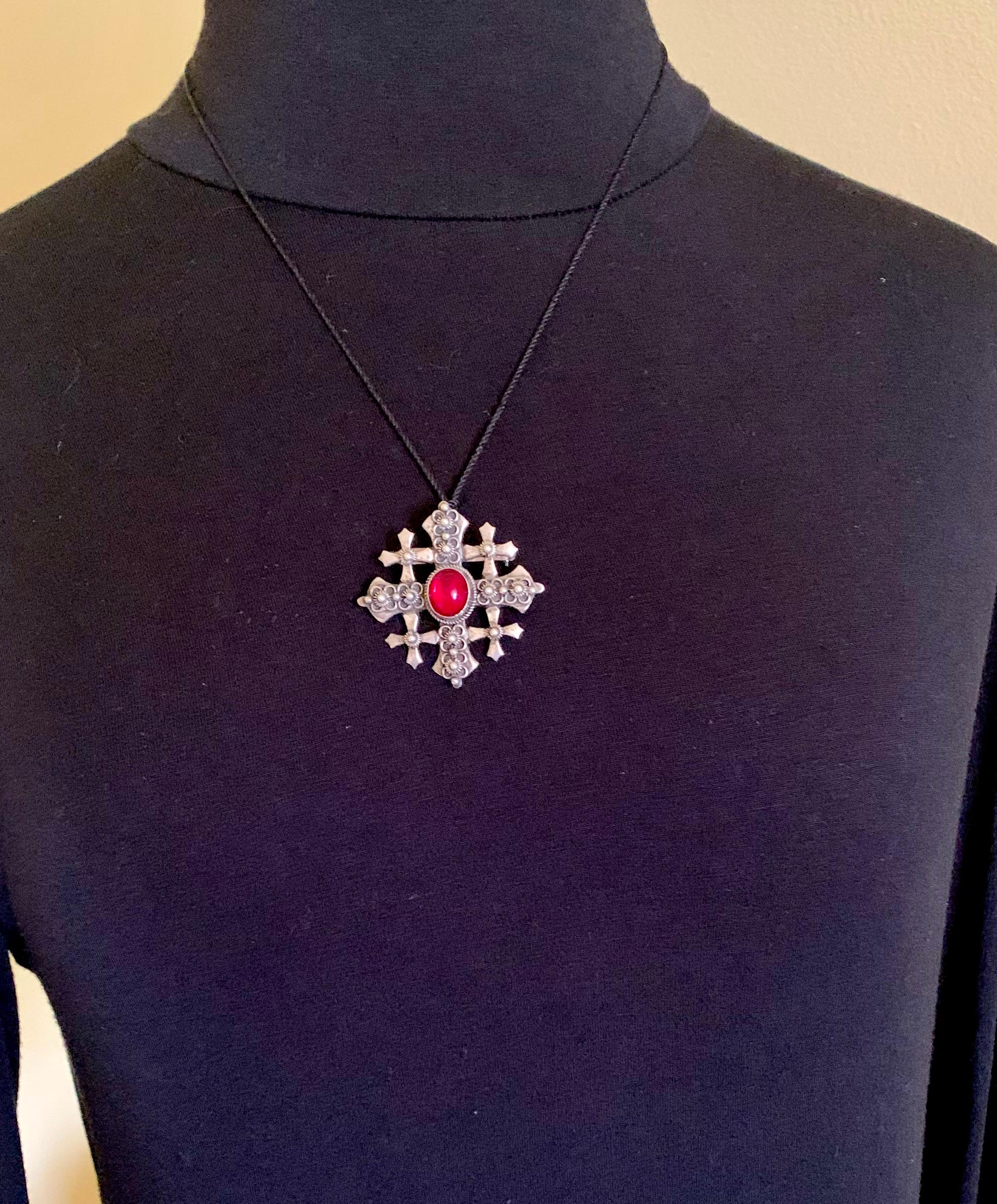 Beautiful Byzantine style large antique silver Five-Fold cross pendant with an oval cabochon garnet glass center, granulation, silver wire decoration with a circular bale for wear as a pendant and a pin back for wear as a brooch.
19th Century
The