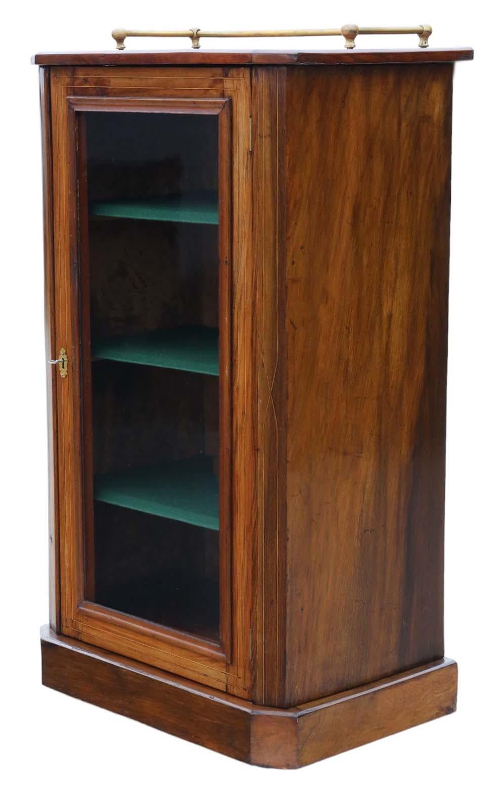 Antique circa 1880 quality inlaid walnut music pier display cabinet, boasting the finest coloration and patina.

This piece is solid and sturdy, with no loose joints, and it comes complete with a key. Its charming marquetry inlay adds to its
