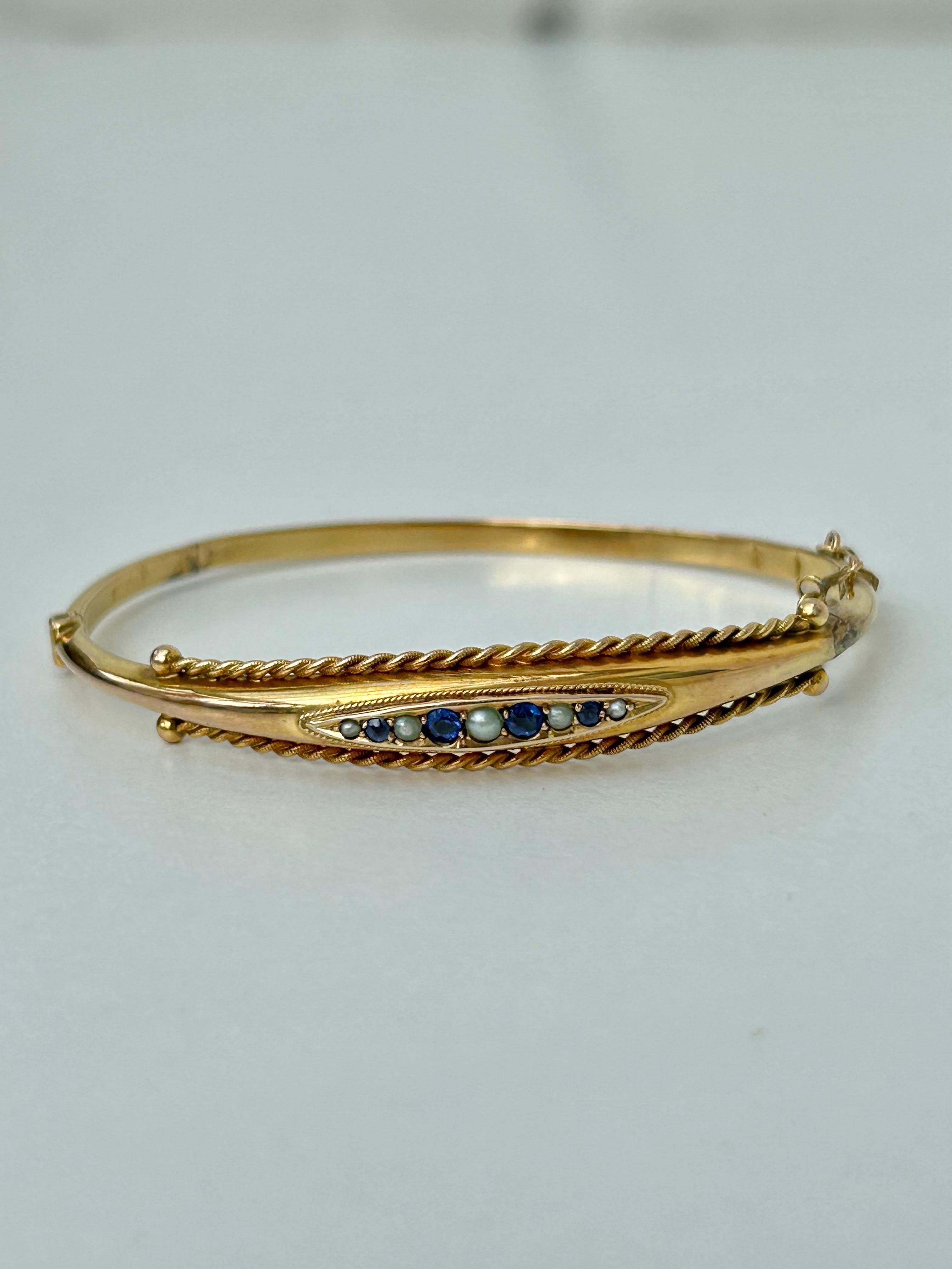 Antique C.1898 Sapphire and Pearl Bangle Bracelet in 9ct Yellow Gold 

delightful sapphire and pearl bangle, so sweet! 

The item comes without the box in the photos but will be presented in a gembank1973 gift box
 
Measurements: Weight 6.19g, inner