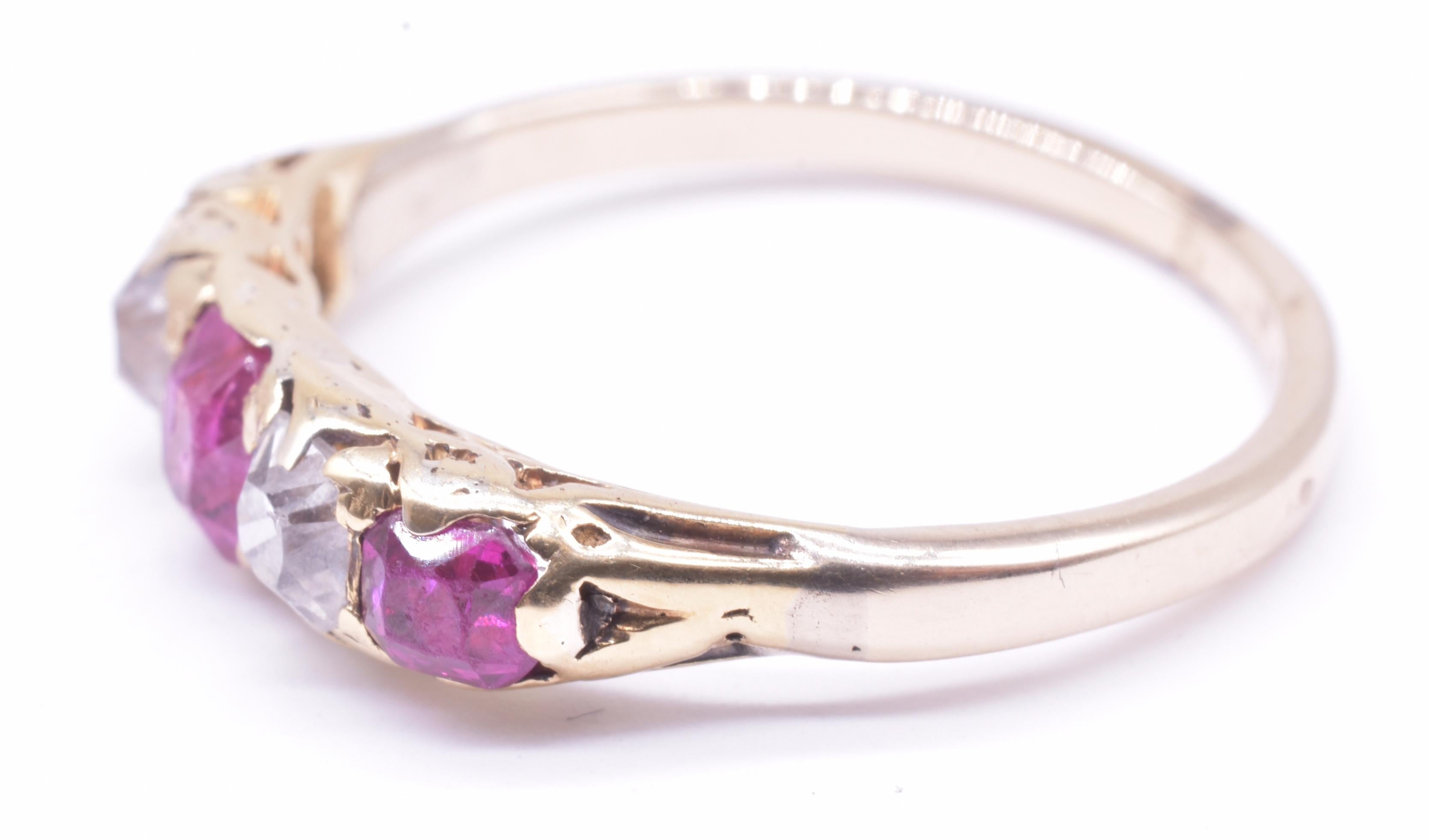 Edwardian 18K yellow gold ruby ring with three clear rubies and two diamonds, in the form of the five stone half hoop ring, with the emphasis on the gemstones. The ring is set 