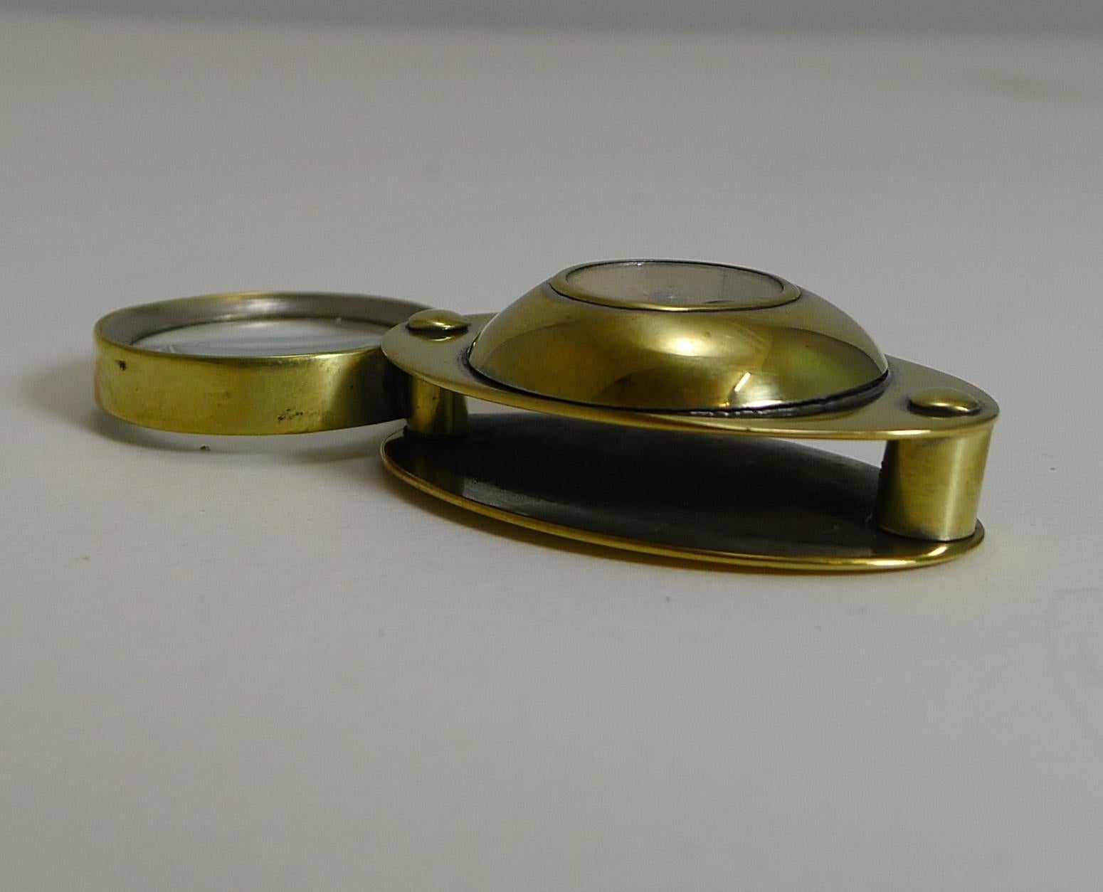 A charming little folding loop or magnifying glass made from brass, dating to the early twentieth century, c.1910.

What of course makes it highly collectable is the inset working compass. A novelty piece in excellent condition. 1 1/2