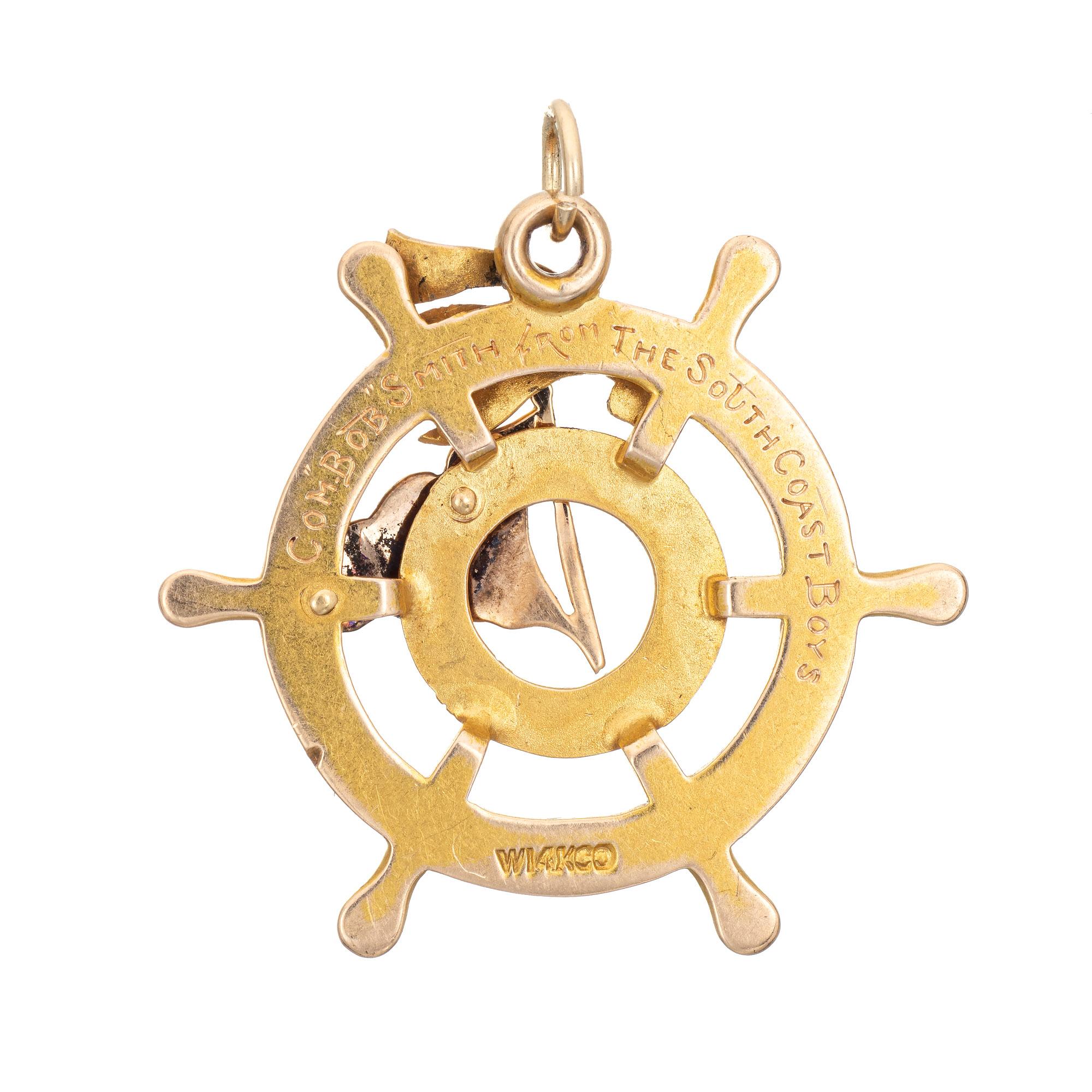 Finely detailed antique Edwardian era Ships Wheel medallion crafted in 14k yellow gold (circa 1910).  

The Ships Wheel features an enameled Burgee nautical flag for the South Coast Yacht Club that later became the Los Angeles (LA) Yacht Club. The