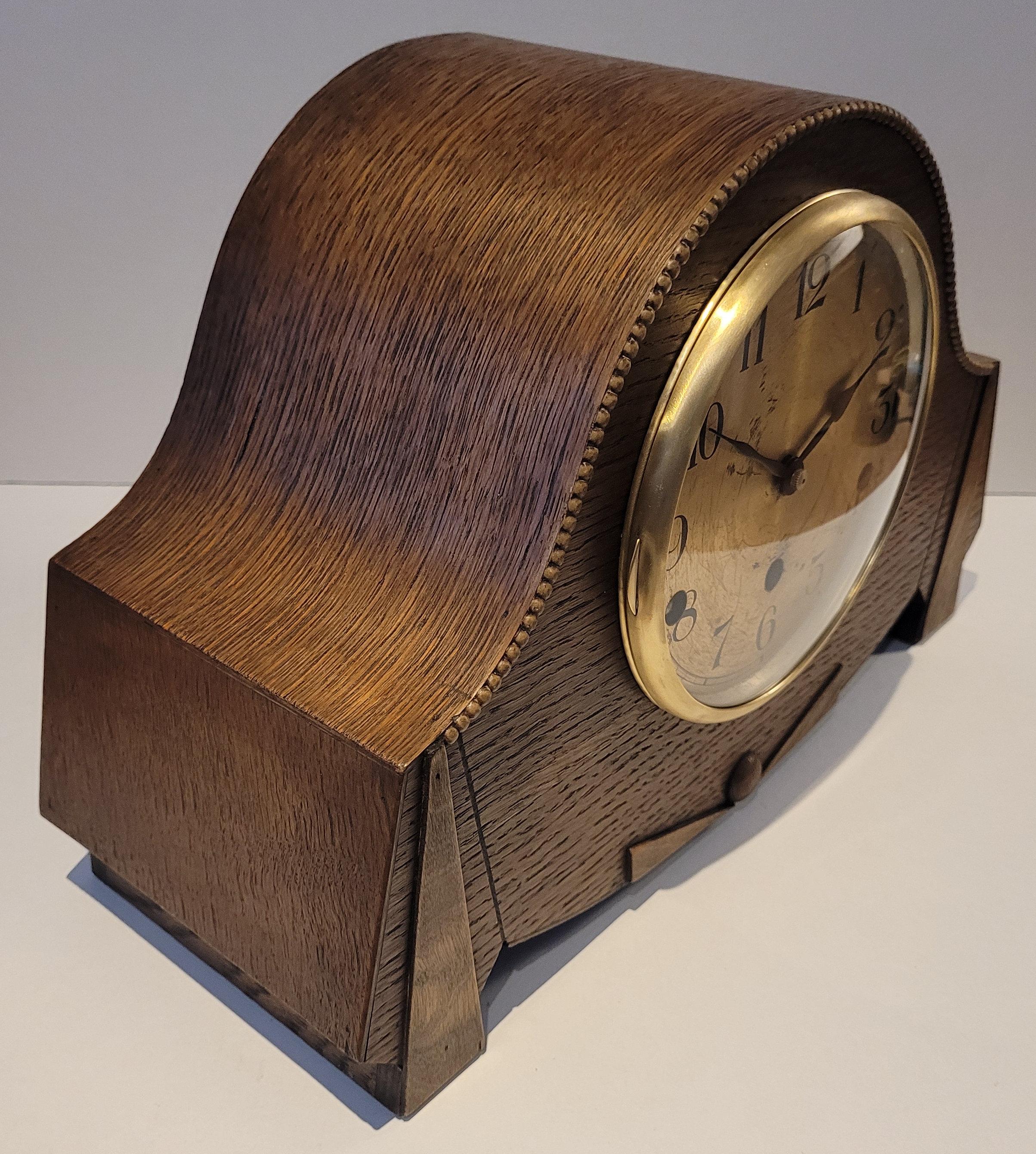 This is an antique c1930's German Westminster chiming mantel clock with silence. This is in outstanding condition and is in full working order. It has a beautiful Art Deco oak body with decorative carvings and beadwork to the front. The oak case has