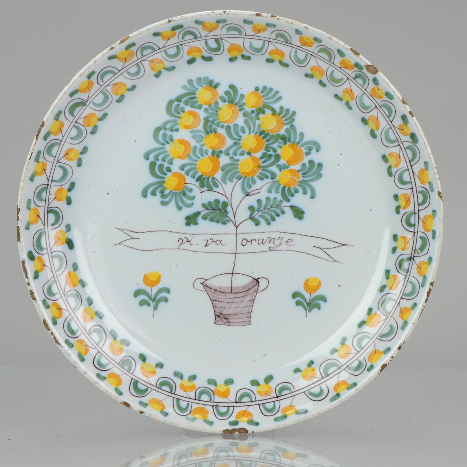 Description

In the center an Orange tree in a tub and a banderole with the inscription 'VI VA ORANJE'. The exclamation VIVA ORANGE first appears on orangist ceramics around 1670-1680. The original dishes from Delft have a dating around 1750-1780