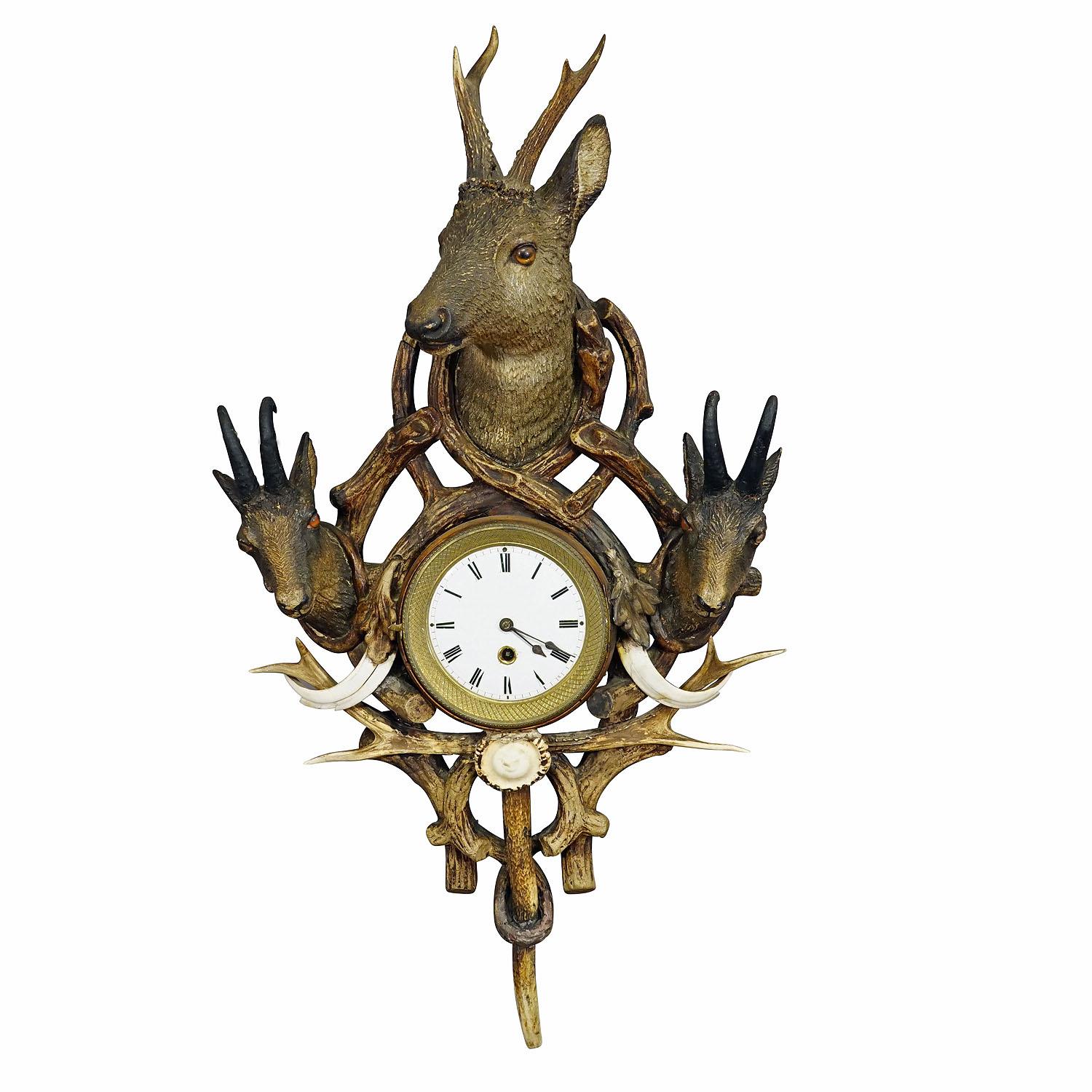 Antique Cabin Antler Wall Clock with Deer and Chamois Austria ca. 1900

A great rustic antler wall clock. The wooden case is richly decorated with plaster applications, a plaster deer head, two plaster chamois heads, antlers from the deer and a