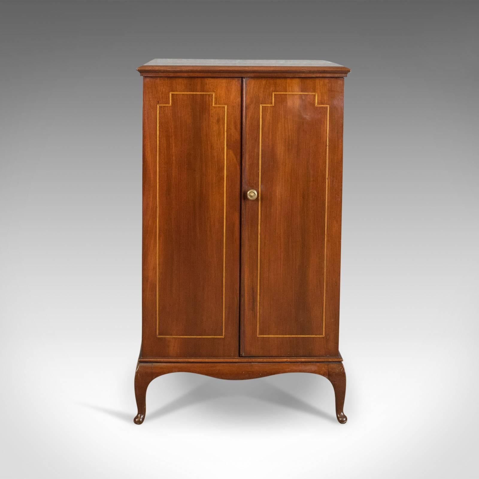 This is an antique cabinet, a filing, side, bedside or nightstand cupboard in mahogany, English and dating to the Edwardian period circa 1910.

Attractive russet tones in the well figured, select mahogany
Good color throughout and a desirable