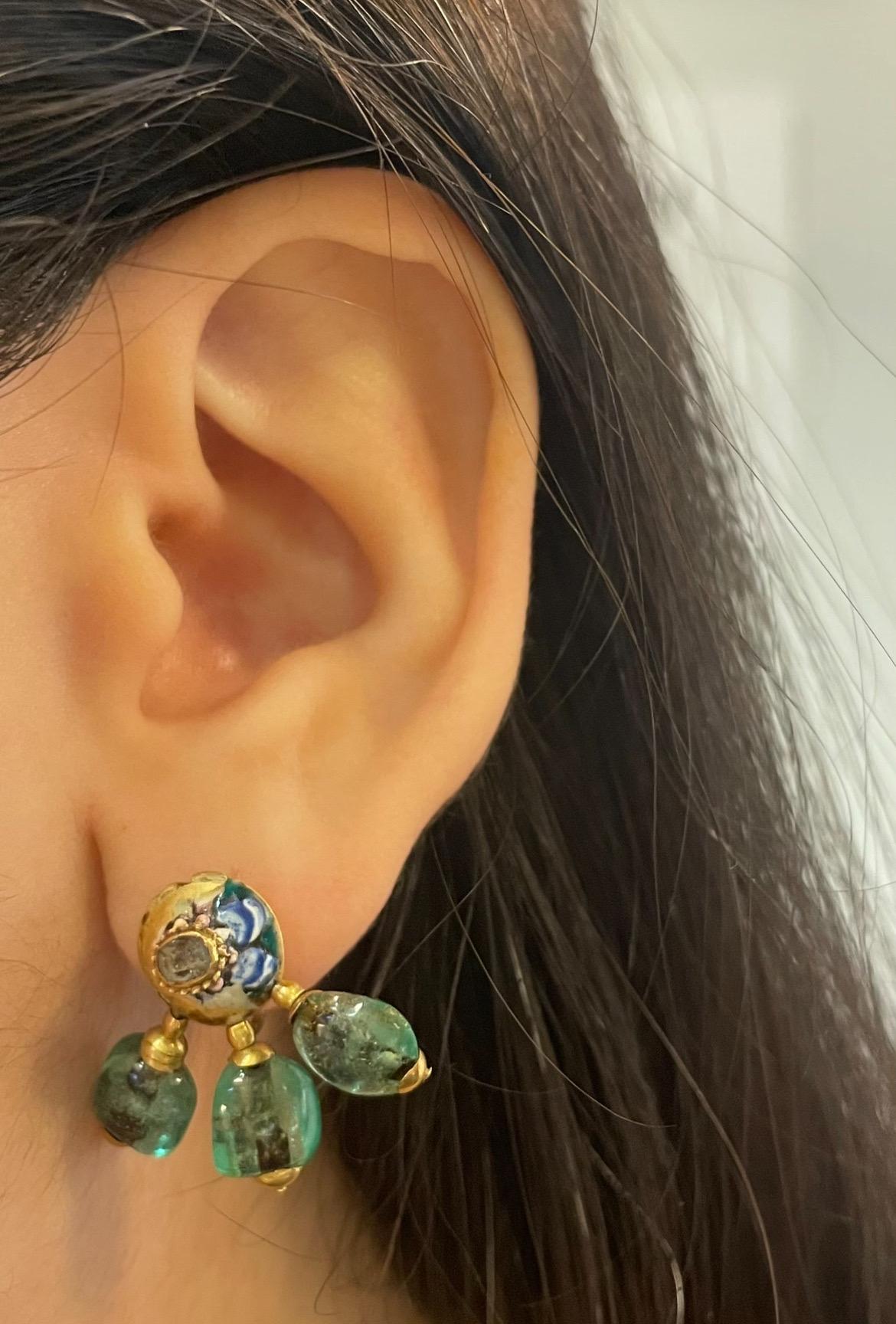 Antique Cabochon Emerald and Enamel Earrings 

A pair of antique yellow gold earrings with enamel, each adorned with three cabochon emeralds and a rose-cut diamond.  

Notably, a similar pendant is exhibited at the Tbilisi Art Palace Museum, where