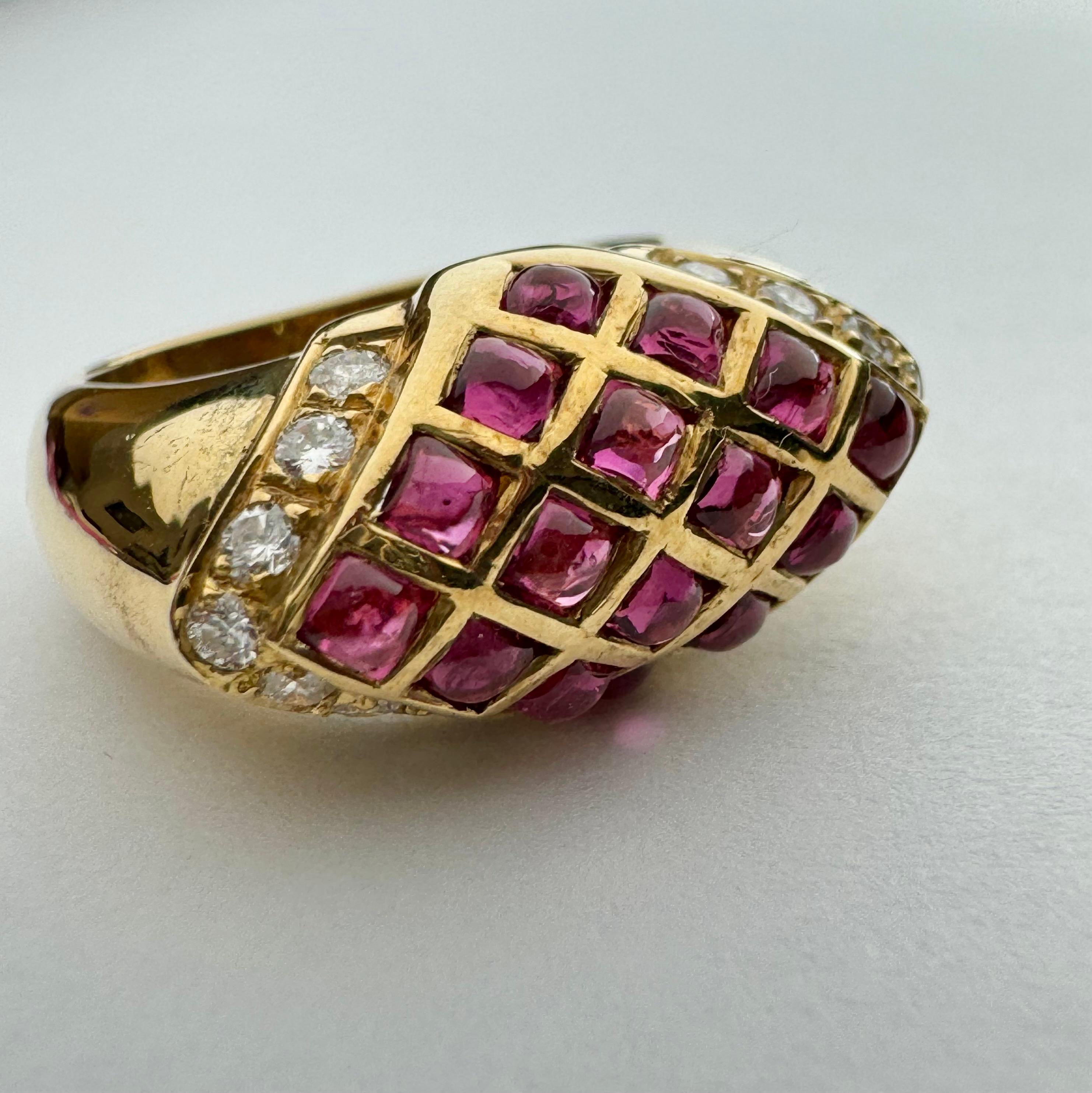 Rare and unique ruby and diamond domed ring, in 14k yellow gold.  The top portion of the ring is cloaked with 16 gorgeous matching cabochon rubies, forming an elegant quilted design.  There are 14 round brilliant diamonds adorning the ends of the
