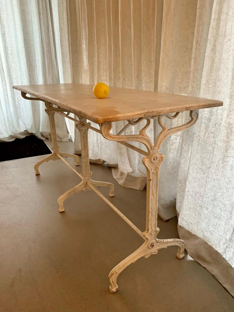 Wonderful antique French café table with patinated marble top - adds a genuine part of the old Parisian café atmosphere to your kitchen, garden or green house. Also works great as a console table. Made by Bouchon, St. Etienne.