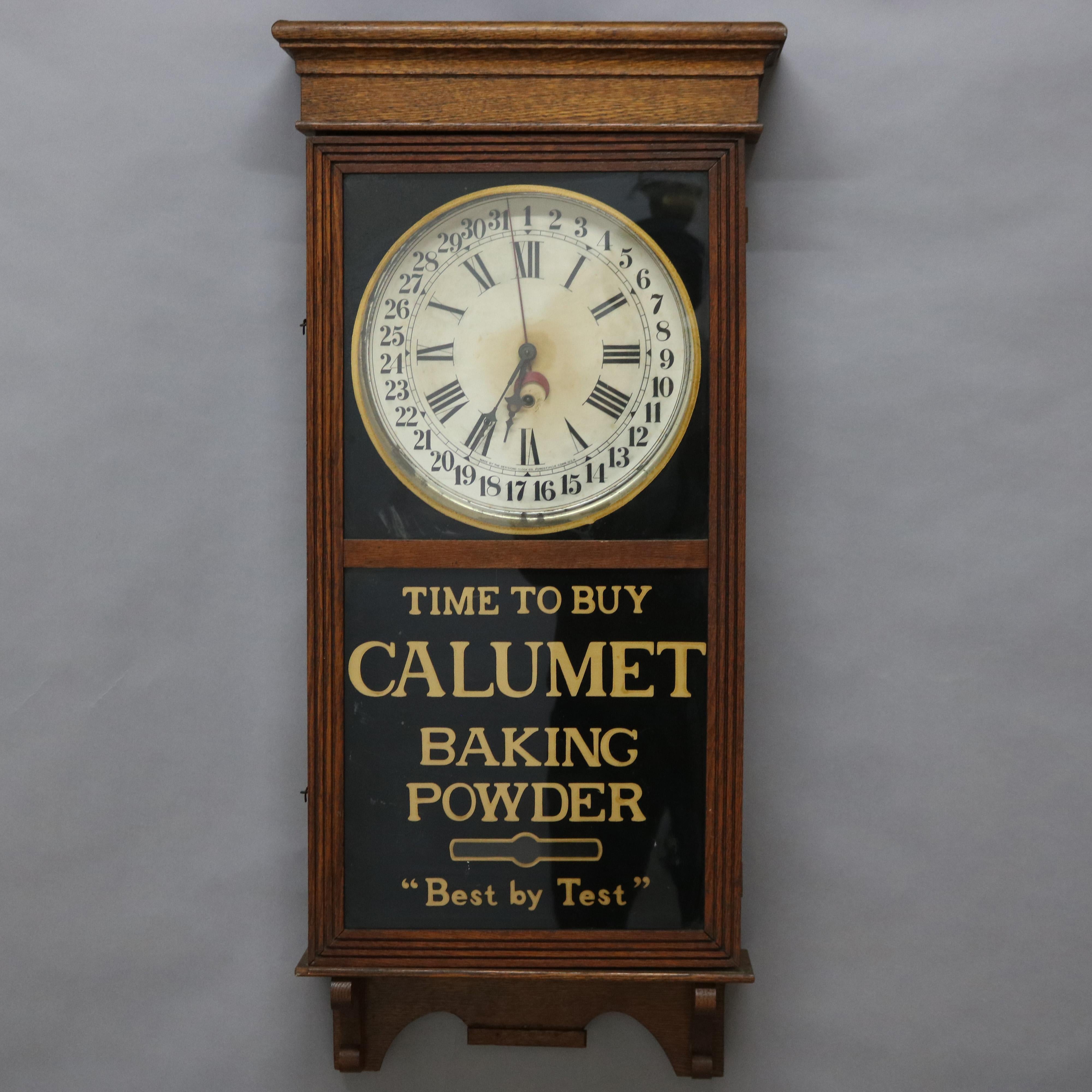 An antique regulator wall clock by Sessions offers oak case with advertisement for Calumet Baking Soda, circa 1890

Measures - 39