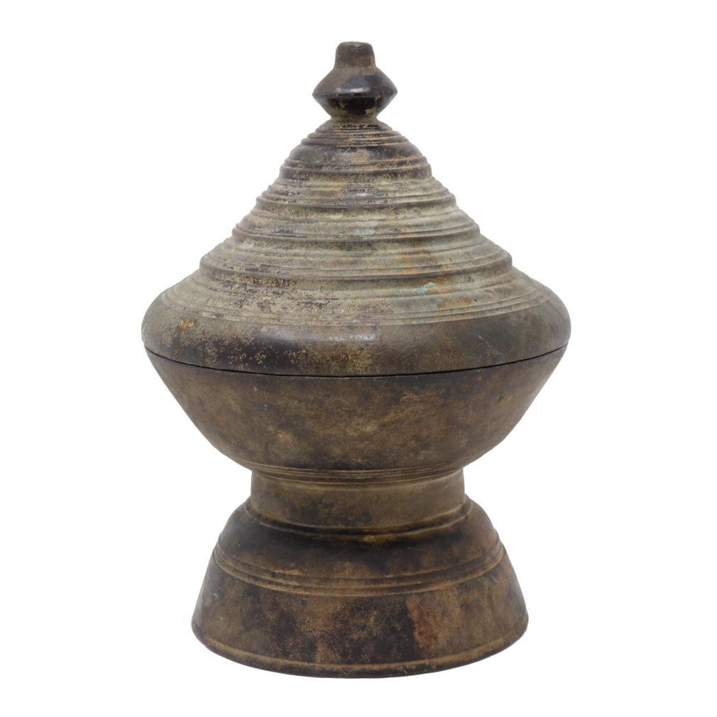 Antique Cambodian Bronze Chetey Betelnut Box.  A cast bronze box with a tight fitting stupa form lid having details of concentric ridges and lotus bud finial. The base with ample space and raised hollow foot. Mottled patina overall with a high iron