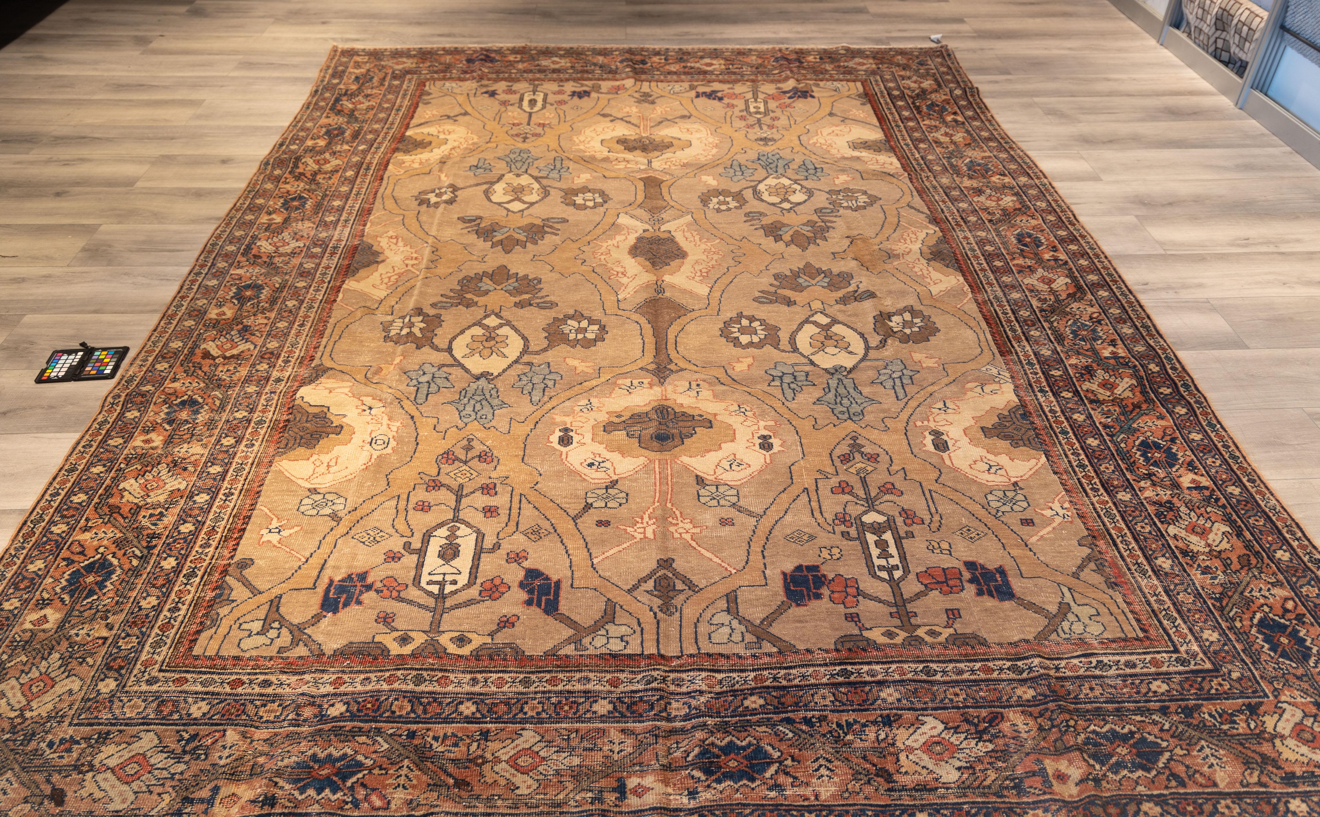 Finely woven antique Mahal rug featuring an elegant allover lattice of palmettes and floral medallions, rendered in muted shades of camel, taupe, and dusty rose. The composition is symmetrical yet organic, with flowing vines and stylized blossoms