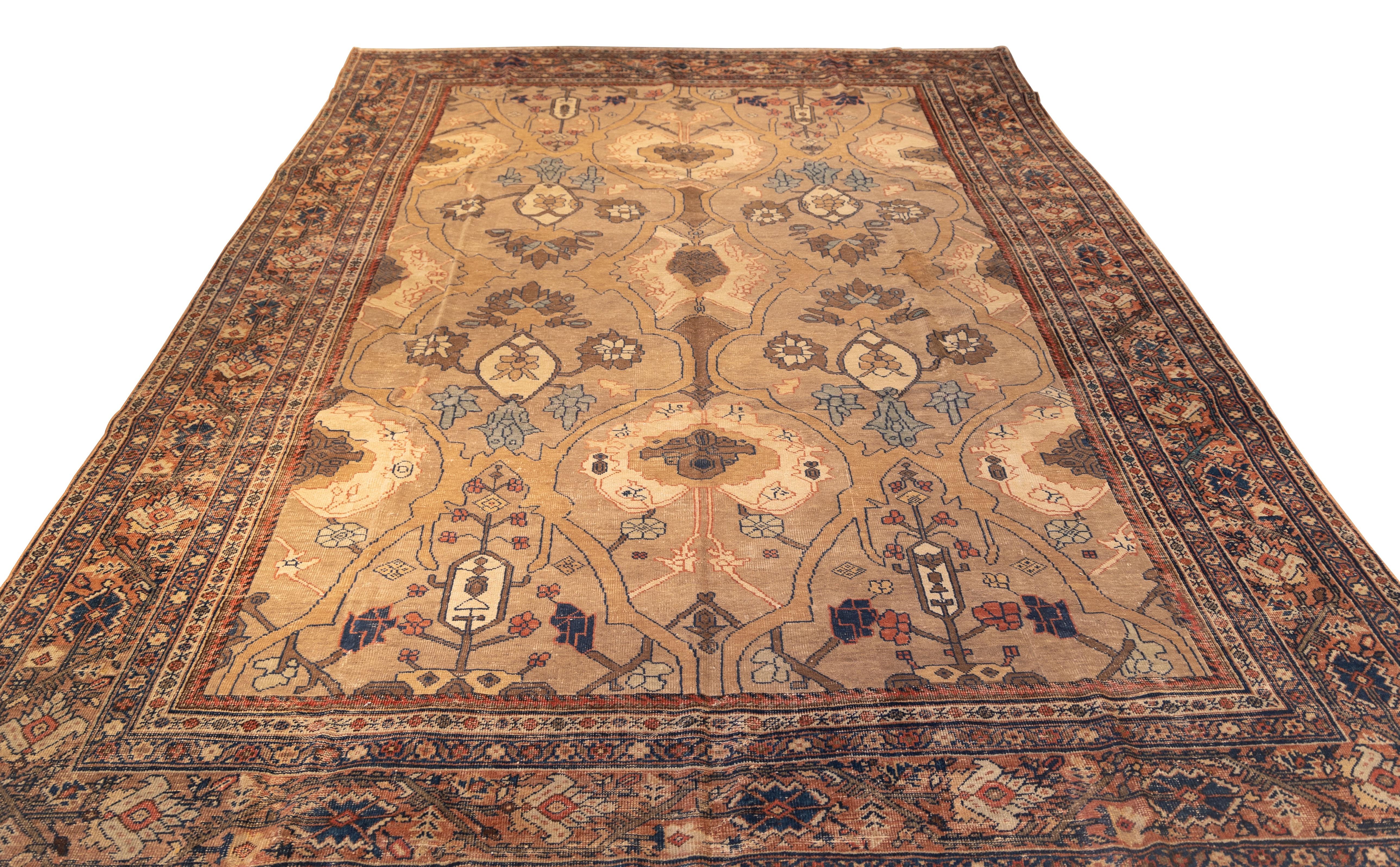 Finely woven antique Mahal rug featuring an elegant allover lattice of palmettes and floral medallions, rendered in muted shades of camel, taupe, and dusty rose. The composition is symmetrical yet organic, with flowing vines and stylized blossoms