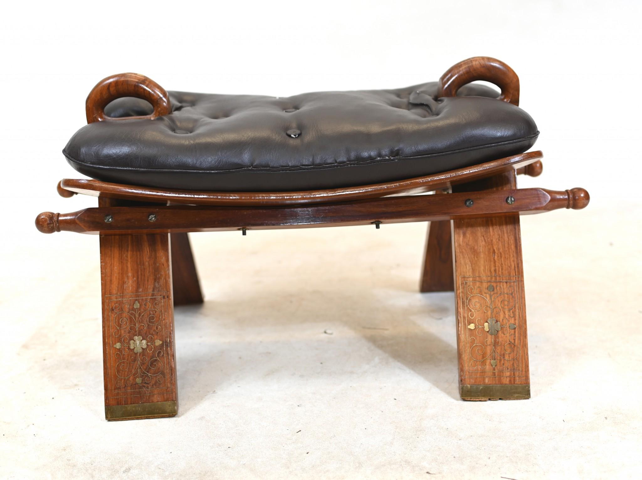 You are viewing a gorgeous camel saddle stool
Hand crafted from mahogany with brass inlay
Great decorative interiors piece
A camel stool is a piece of furniture that was traditionally used for riding camels in the Middle East and Africa, but can now