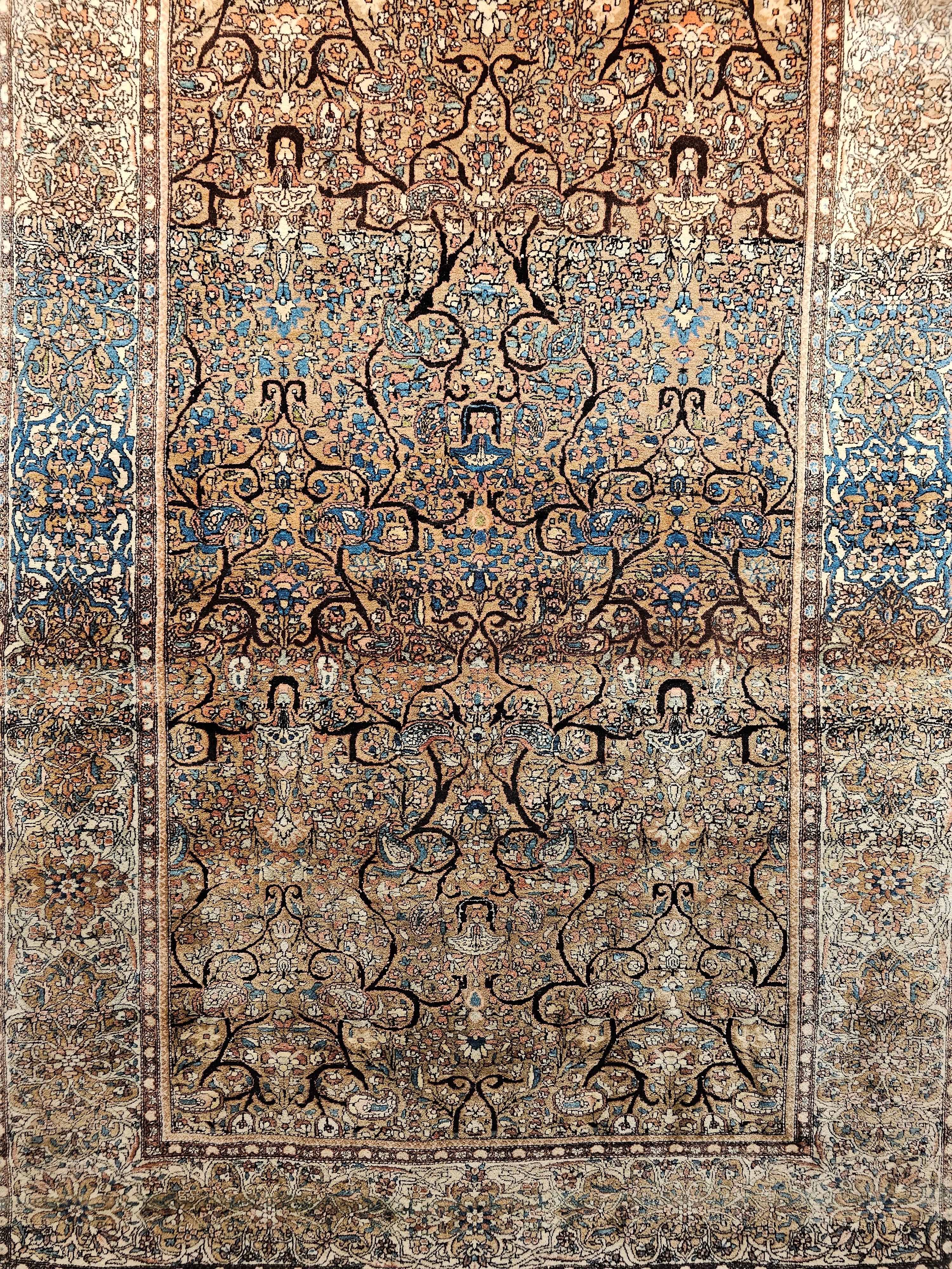 A Camelhair Persian Farahan Area Rug with an Allover Botanical Design from the Late 1800s. The rug has a camelhair field which contains an allover floral design with meandering branches in brown colors throughout. There is a beautiful abrash color,
