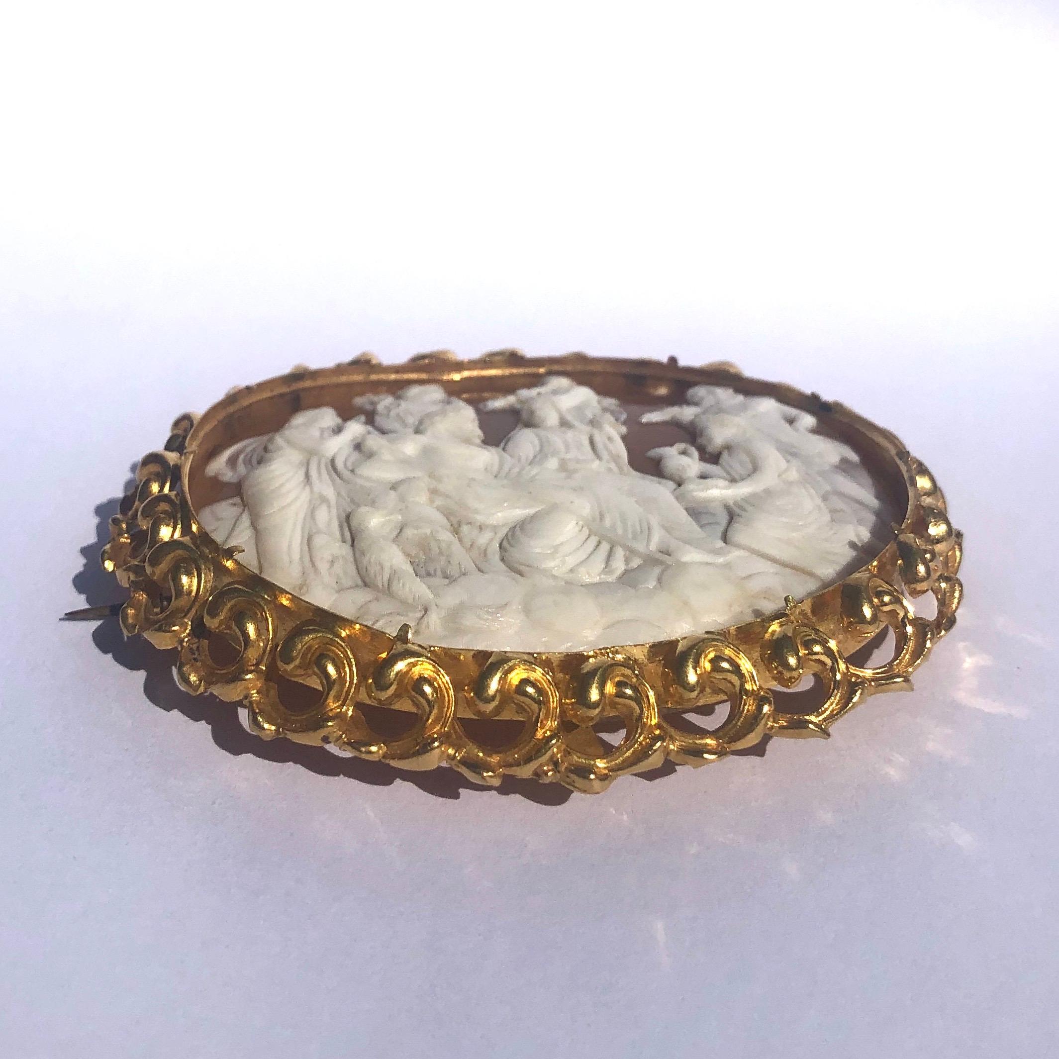 This fabulous extra large cameo brooch is made out of carved shell and the detail is exquisite. As you can see in the images the fine detail that is shown is absolutely stunning. The scene is framed by an ornate 15ct gold scroll detailed frame and