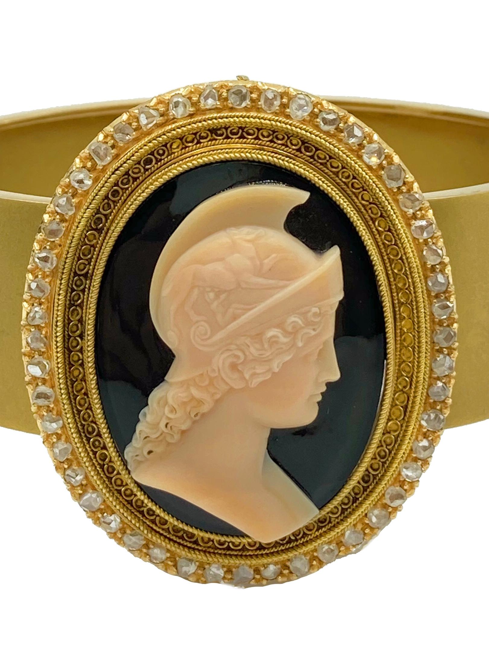 An antique onyx cameo, encircled by rose cut diamonds, mounted on a yellow gold cuff bracelet.