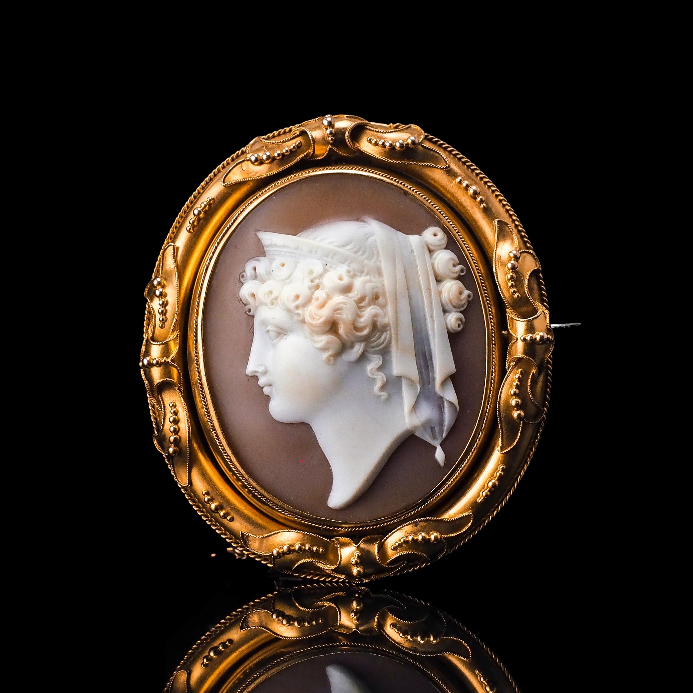 Bienvenue chez Artisan Antiques, basé à Mayfair, Londres - Nous sommes ravis de vous proposer cette magnifique broche/pendentif en camée coquillage en or 18ct, fabriqué vers 1860, représentant une figure de proue d'Héra - déesse mythologique grecque