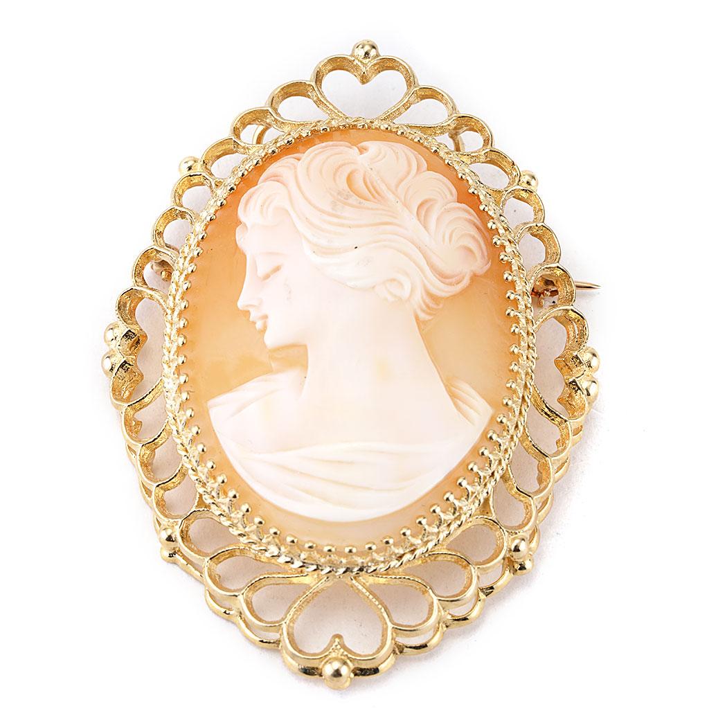 This antique cameo pin and pendant with heart bezel is made of 14K yellow gold. Measurements are 2