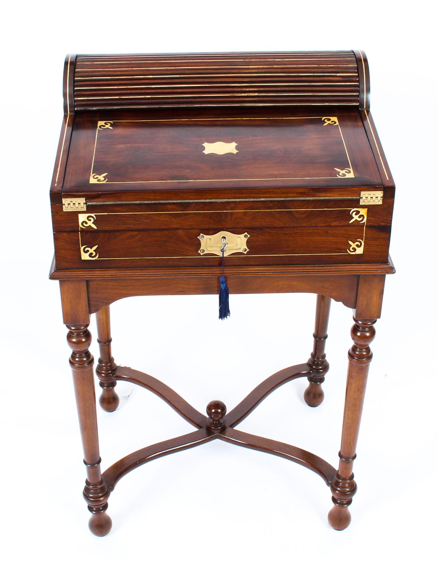 Fine quality Anglo-Indian Padouk tambour fall fronted Campaign writing slope on stand, circa 1840 in date.

This superb writing slope desk would have been made for military officers in the field.

Brass inlaid with striking cut brass decoration and