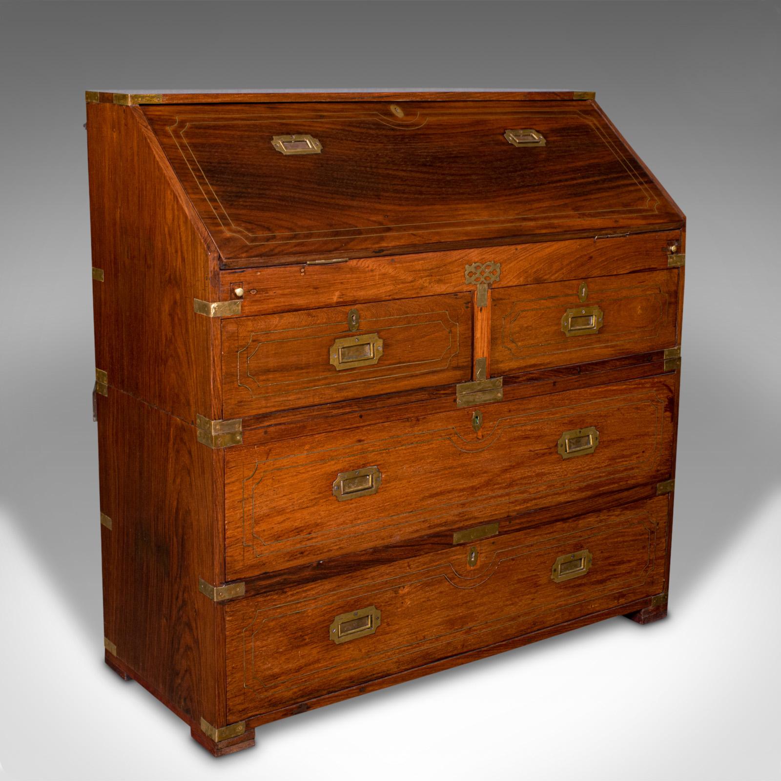 This is an antique campaign bureau. An Anglo-Indian, teak and brass colonial writing desk, dating to the late Victorian period, circa 1900.

Rare and unusual example of campaign furniture, with a superb finish and well appointed
Displaying a