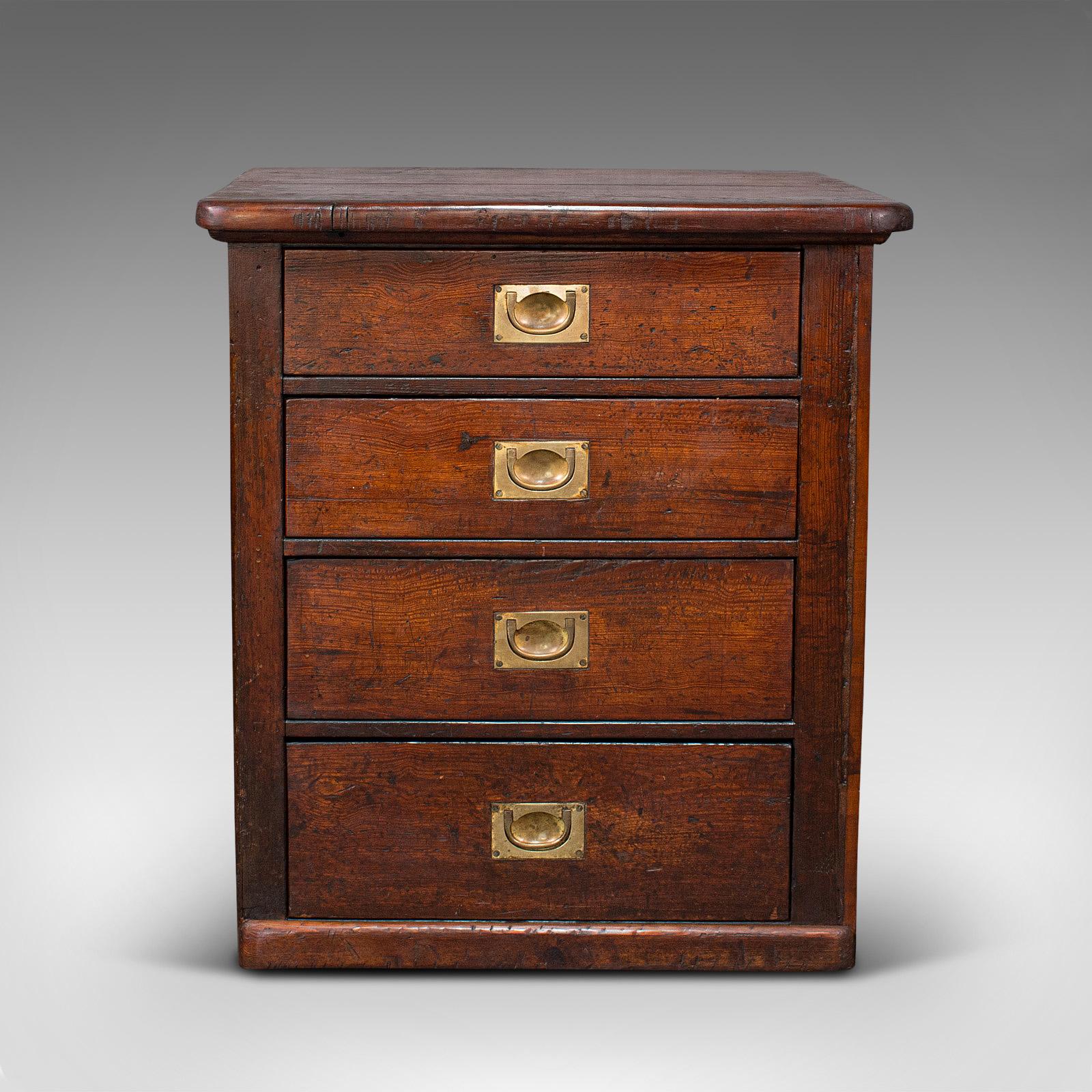 This is an antique Campaign chest of drawers. An English, pitch pine shop retail cabinet, dating to the Victorian period, circa 1870.

Of generous proportion and Victorian Campaign appeal
Displaying a desirable aged patina - some gentle wear