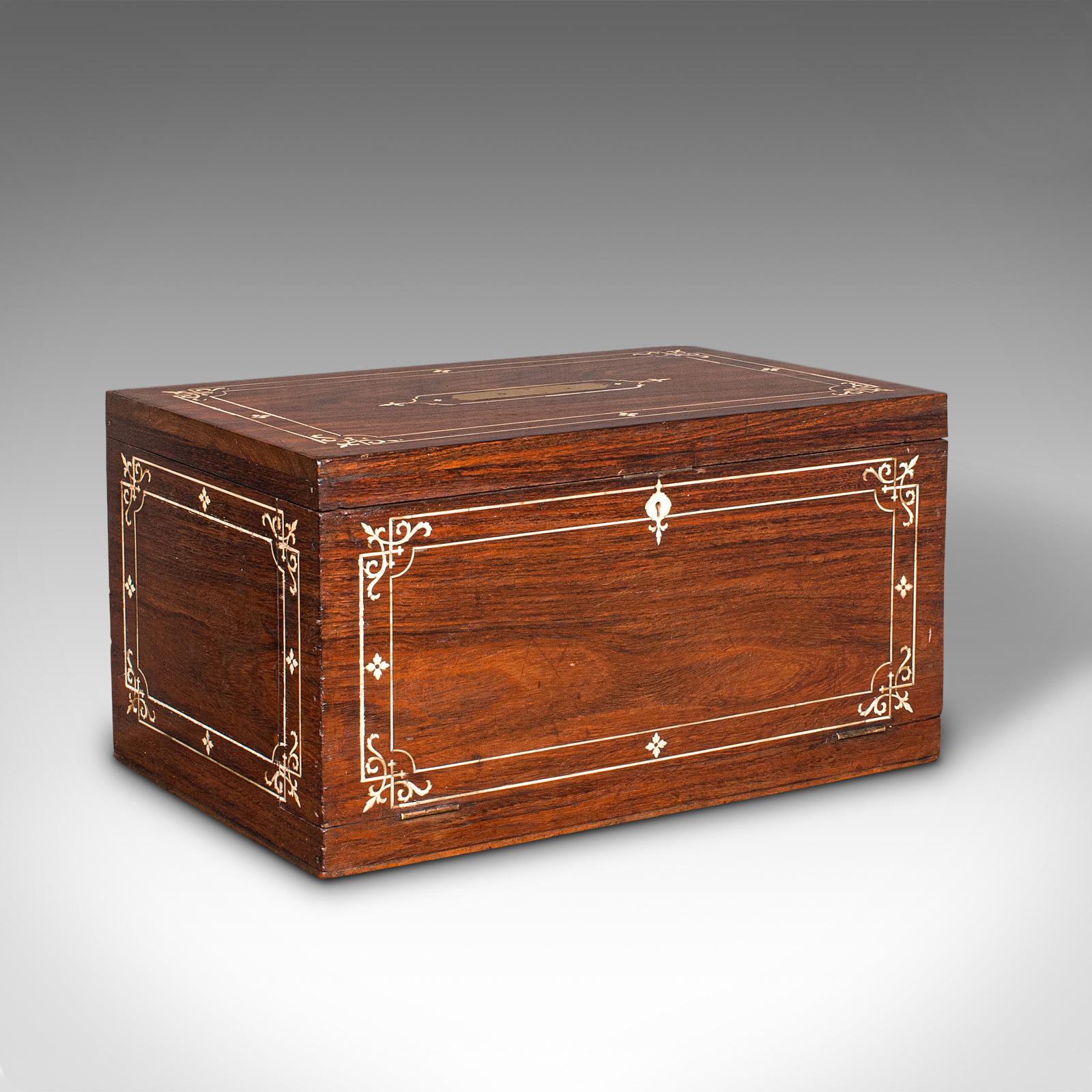 This is an antique campaign correspondence box. An Anglo-Indian, teak and bone inlaid colonial writing case with fitted interior, dating to the late Victorian period, circa 1900.

Enticing writing box with a delightful array of hidden