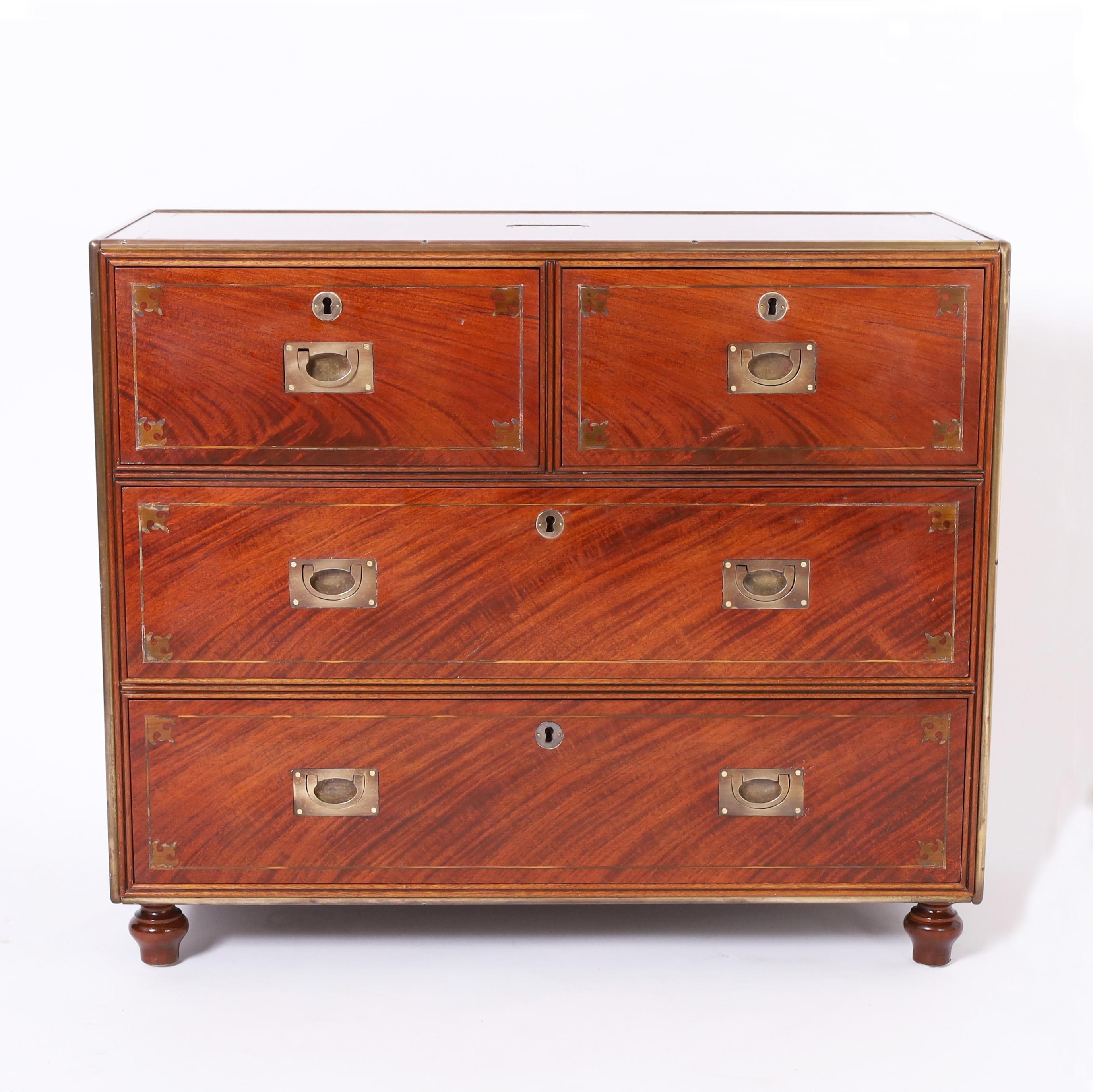 Intriguing antique campaign style chest crafted in mahogany with well placed dramatic grains, brass inlays and hardware, keys for all drawers and turned feet. Reputedly made from reclaimed wood from the paddle steamer 