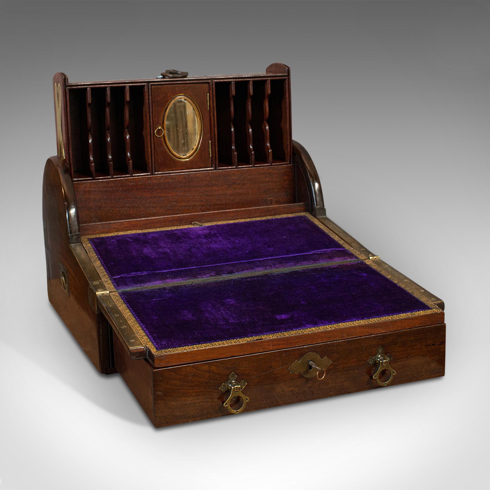 This is an antique campaign writing slope. An English, mahogany ship's captain's correspondence desk, dating to the Victorian period, circa 1850.

Superior campaign piece with captivating roll-top action
Displays a desirable aged patina
Select