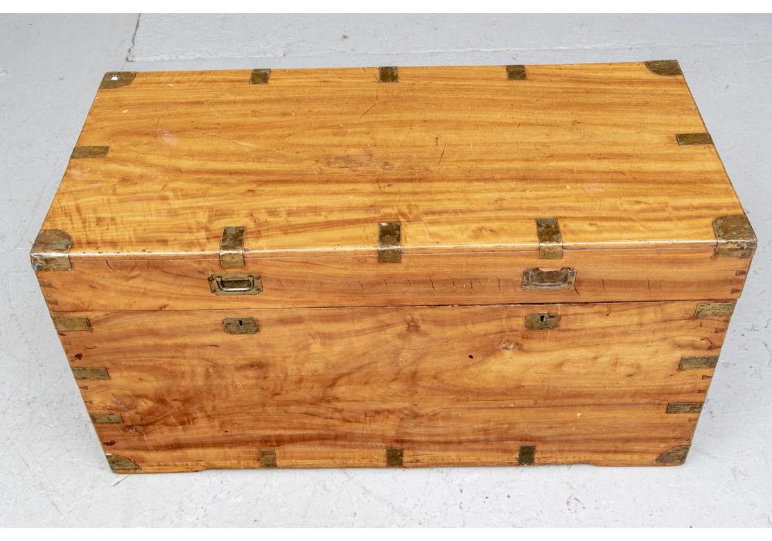 An antique camphor wood Campaign style trunk with hand-cut dove tail joinery, recessed front handles, drop pull handles on sides, double locks with one working key, 4-hinge lid, metal corners and brackets, interior box with cover. With Key.