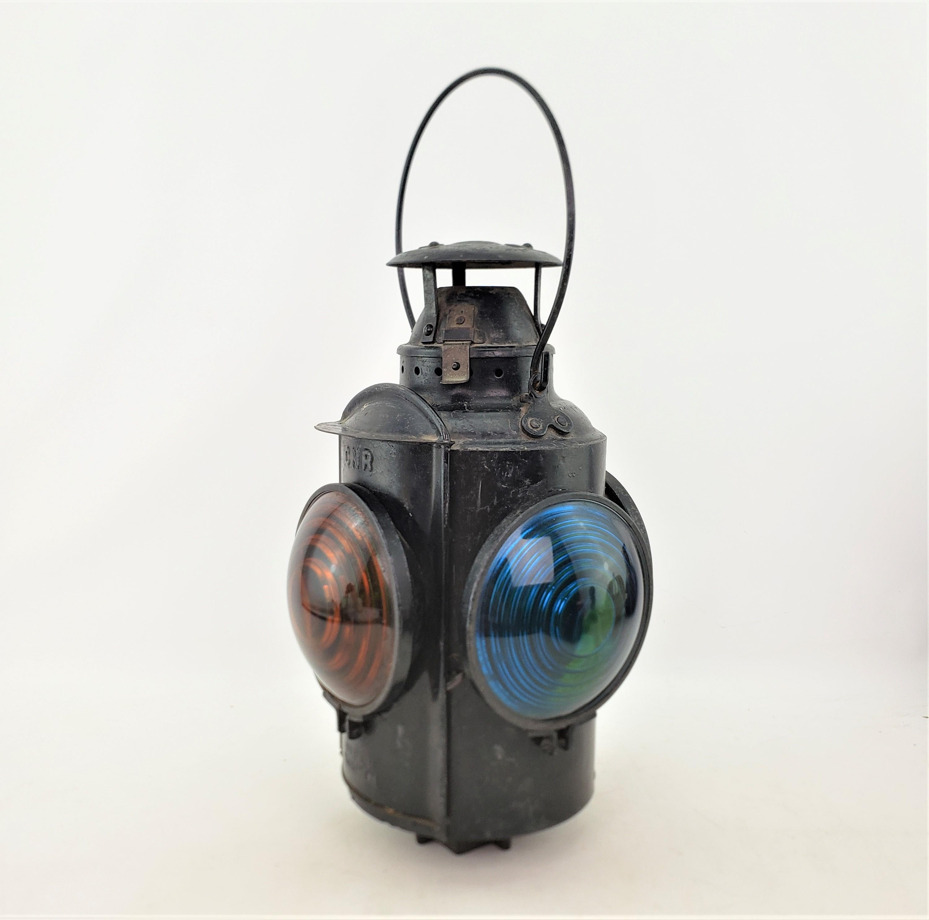 This antique railroad lantern was made by the Hiram L. Piper Company of Canada and date to approximately 1920 and was made for the Canadian National Railroad. The lantern has a heavy metal exterior shell with amber and green molded glass lenses. The