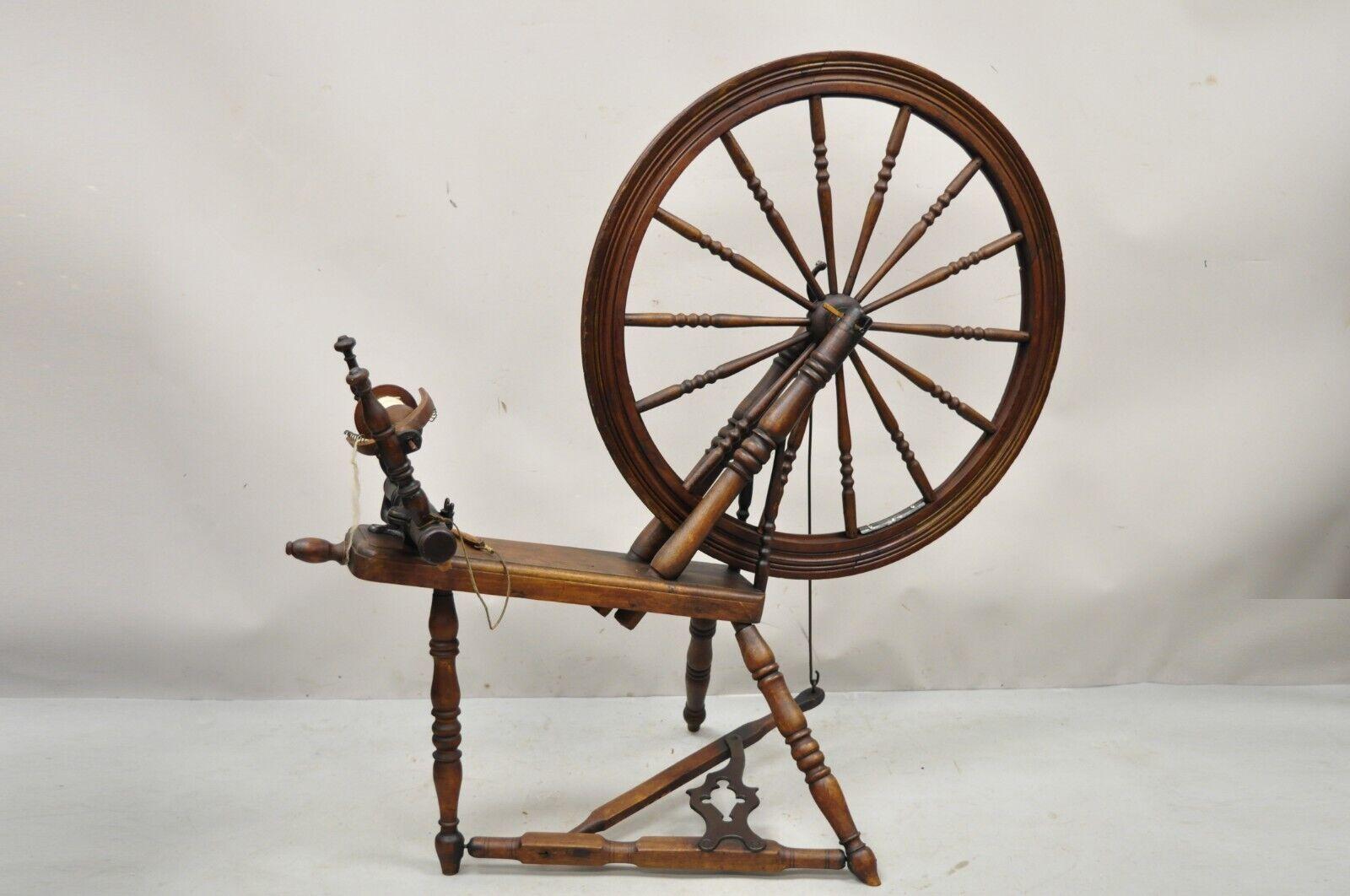 Antique Canadian Primitive Country wooden colonial spinning wheel. Item features cast iron hardware, solid wood construction, beautiful wood grain, very nice antique item, quality American craftsmanship. Old restoration label to underside which