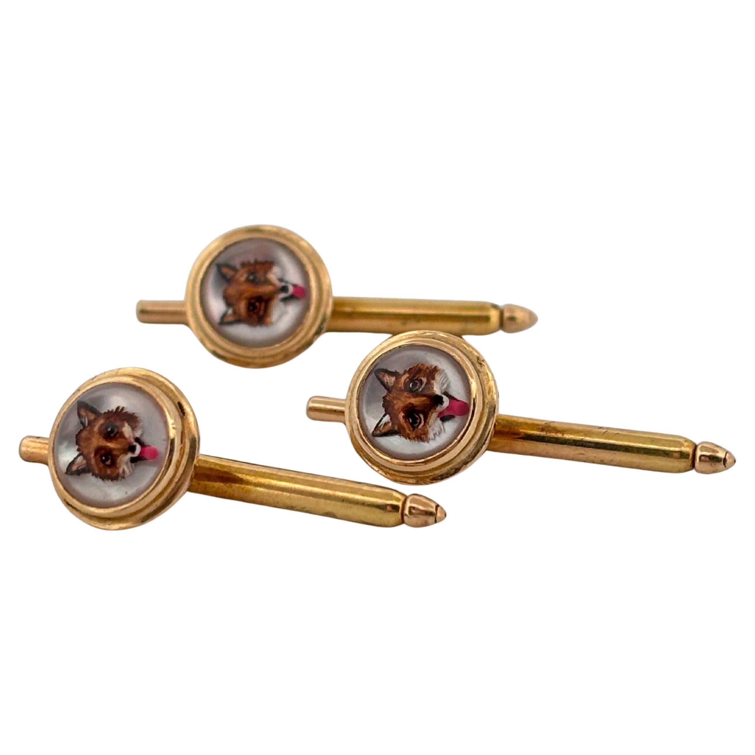 This fine set of three antique Canadian reverse-painted buttons is a rare example of early sporting and decorative jewelry art. Crafted in warm 14k yellow gold, each button measures approximately 1.00 inch in length and together weigh 3.7 grams. The