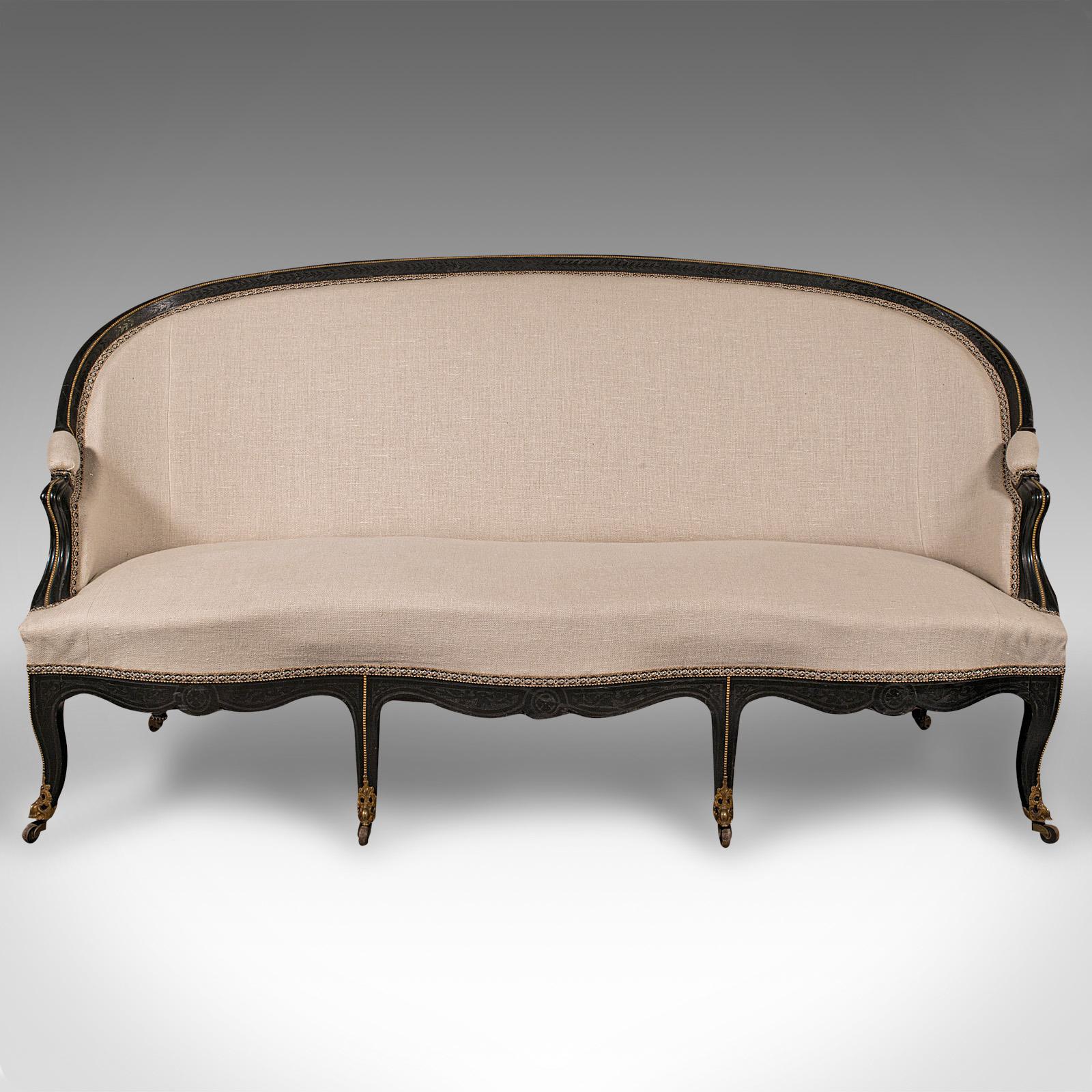 This is an antique canapé sofa. A Continental, ebonised wing settee in Louis XV revival taste, dating to the mid Victorian period, circa 1870.

Exudes quality and the quintessential revival taste of Louis Xv craftsmanship
Displays a desirable