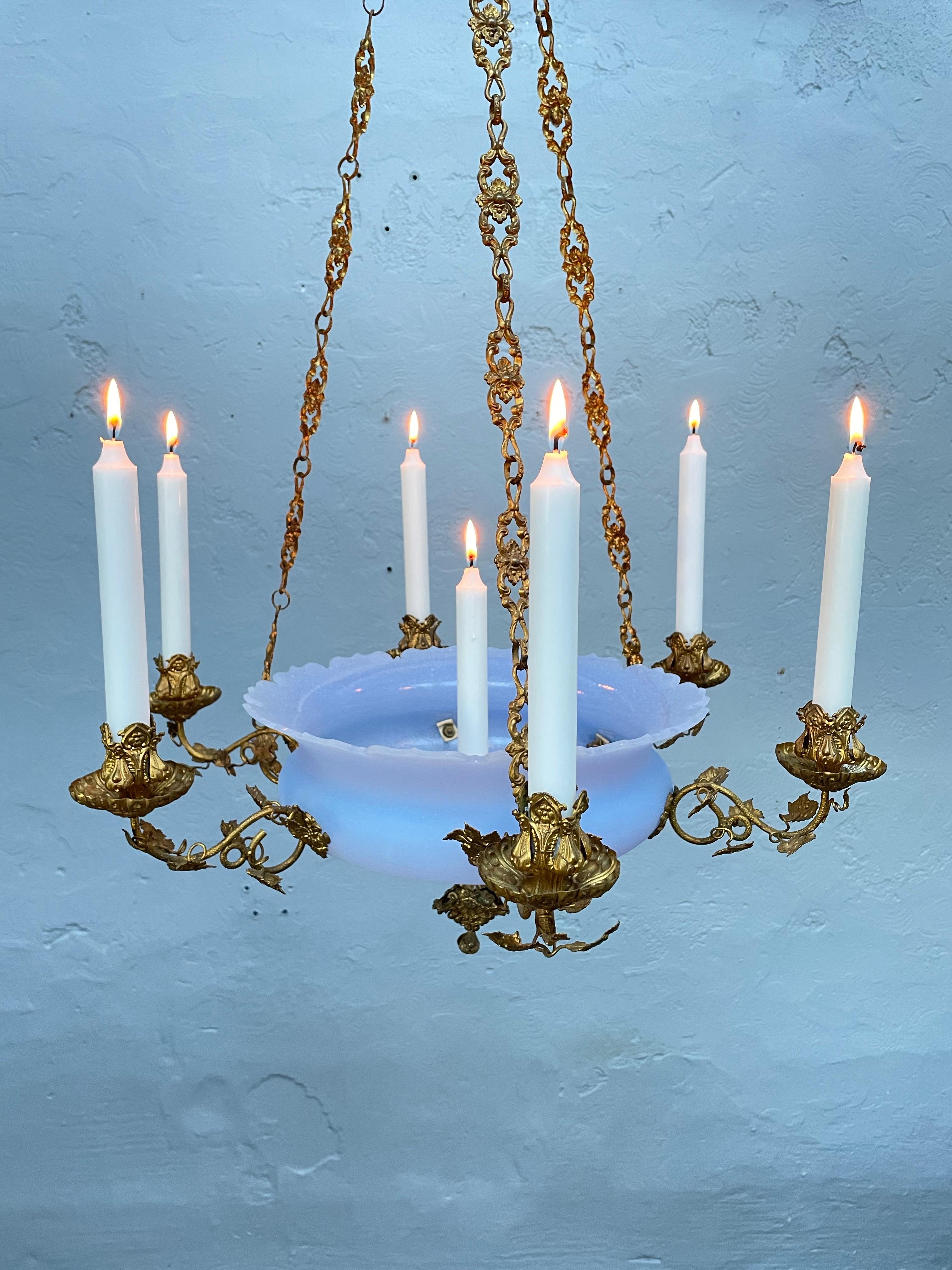 Antique 6 arm Candelabra from the 1800s
Also one candle holder in the center of the blue glass shade so a total of 7.
Most probably French Rococo Revival in blue glass with brass fittings.
Richly decorated in brass vine leaves on the candle holders,