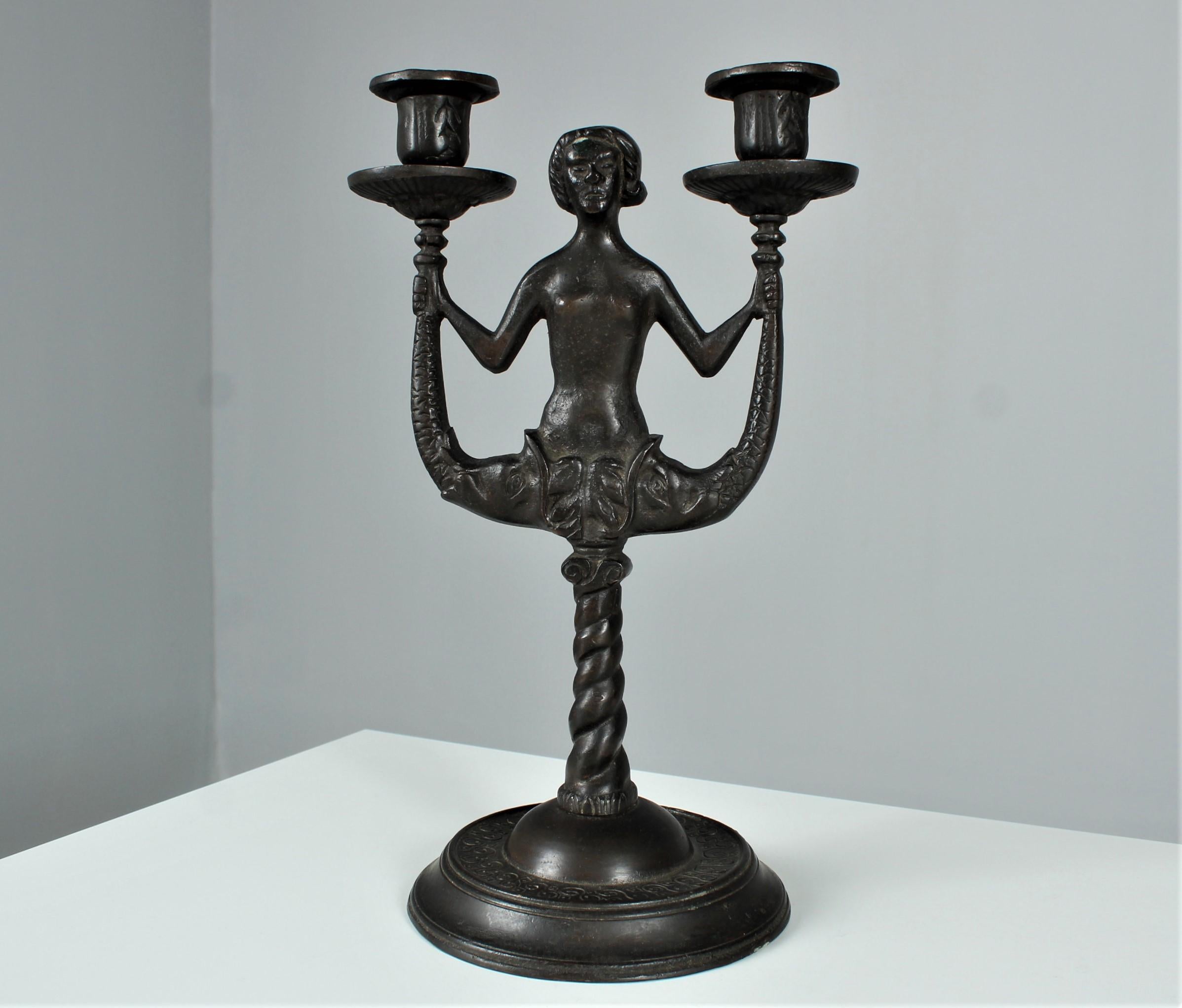 Exceptional antique candlestick made of patinated bronze.
Great very heavy bronze work.
Depicting a fantasized figure with two fish instead of legs.
Probably France, around 1920 / 1930.