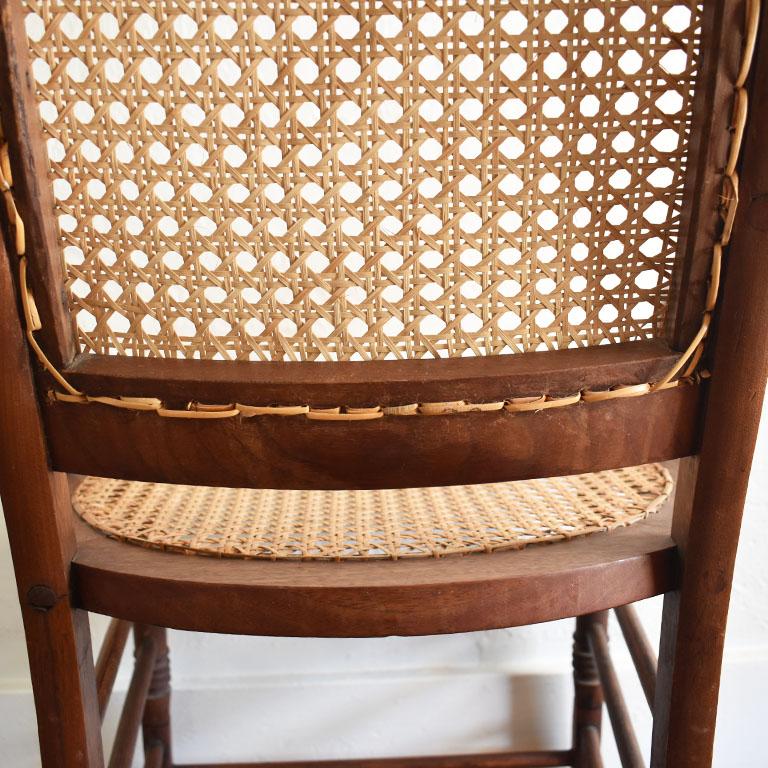 American Antique Cane and Carved Wood Arm Side Chair with Rose Detail For Sale