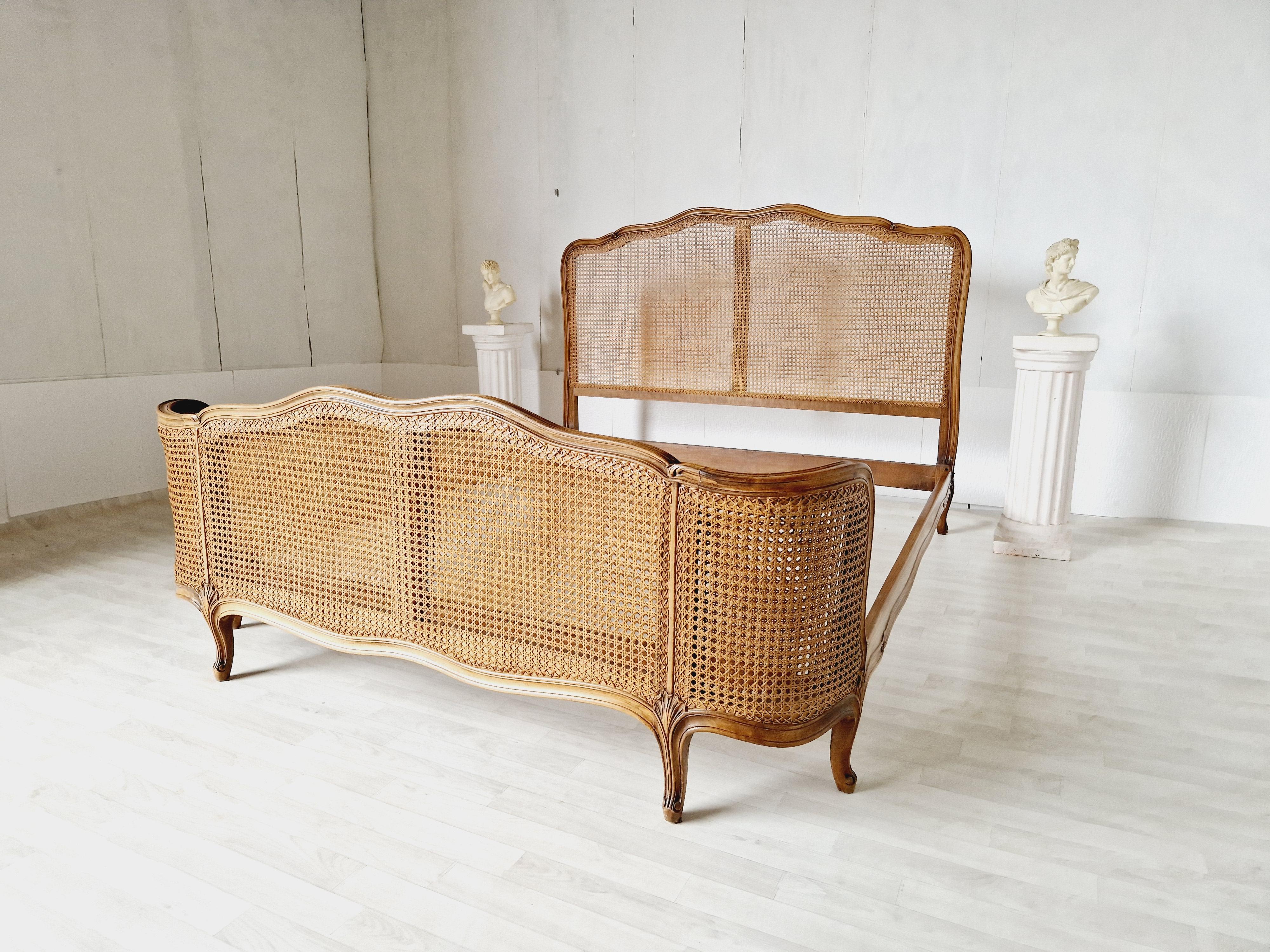 
We are delighted to offer for sale this Cane Corbeille Bed.

This exquisite antique bed will transport you back in time to the elegance of 1920s France. Crafted in the Louis XV style, this Rocaille bed features delicate carvings and a fabulous wood