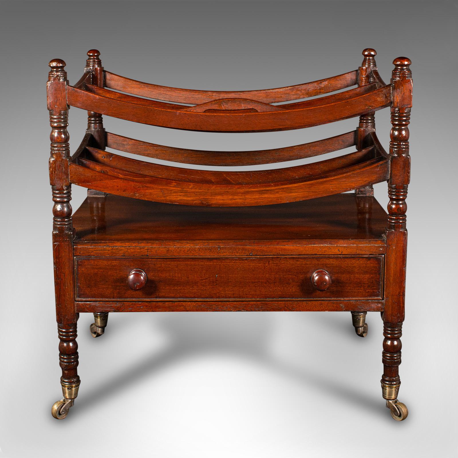 This is an antique Canterbury stand. An English, mahogany and oak four compartment magazine rack, dating to the Regency period, circa 1820.

Appealing late Georgian craftsmanship, ideal for the living room or conservatory
Displaying a desirable aged