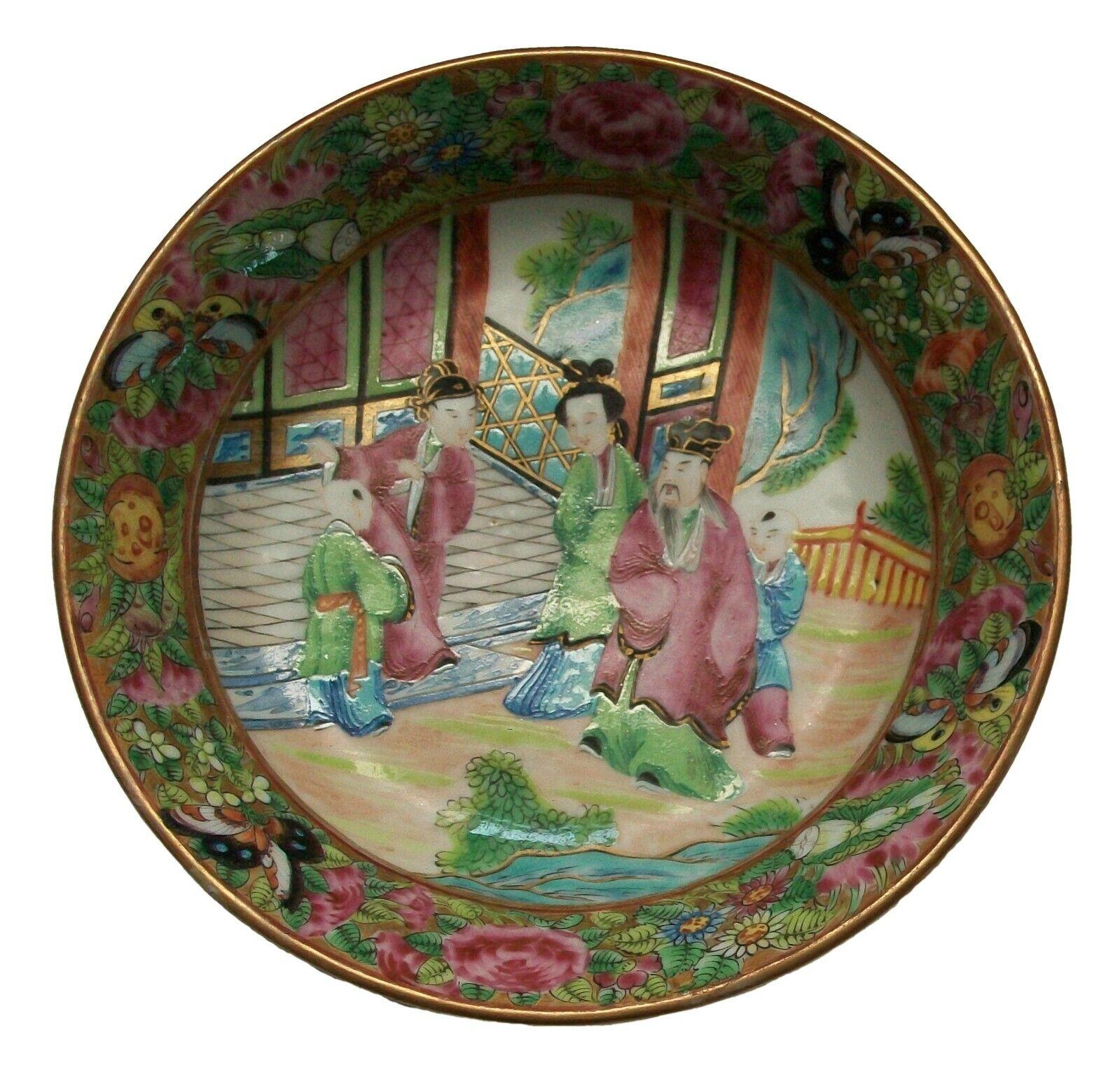 Antique 'famille rose' (also referred to as 'rose medallion') porcelain plate - hand painted with a courtyard scene to the center - floral and foliate border with butterflies on a gilt ground - gilded highlights among the colorful enamels - unsigned