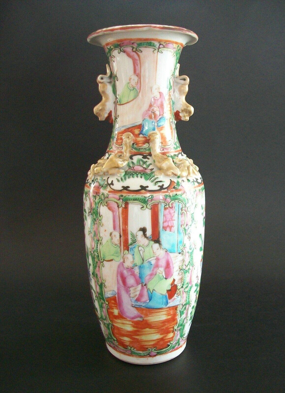 Antique 'famille rose' (also referred to as 'rose medallion') porcelain vase - hand painted with enamels of a courtyard scene - floral and foliate borders - gilt decorated applied figures to the shoulder and handles to the neck - unsigned - China -