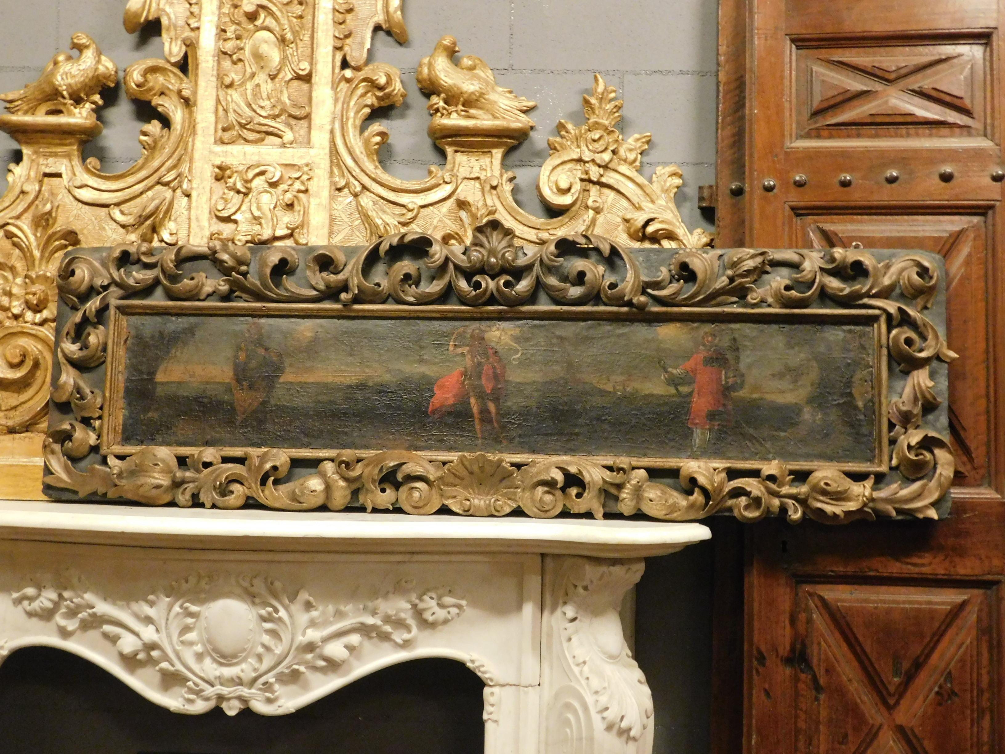 Antique wooden panel with applied hand painted canvas, very rich and hand carved, deep gold frame on a black background, it represents a biblical scene from an 18th century church in Italy,
usable as panel for wall decoration, picture, or as