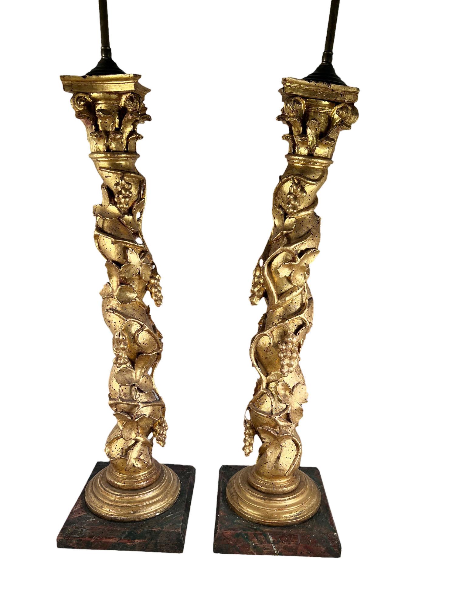 A pair of 18th century Italian Solomonic gilded columns with fruit and vines carved surround. The columns are circa 1780 and themselves are twenty seven inches long.
