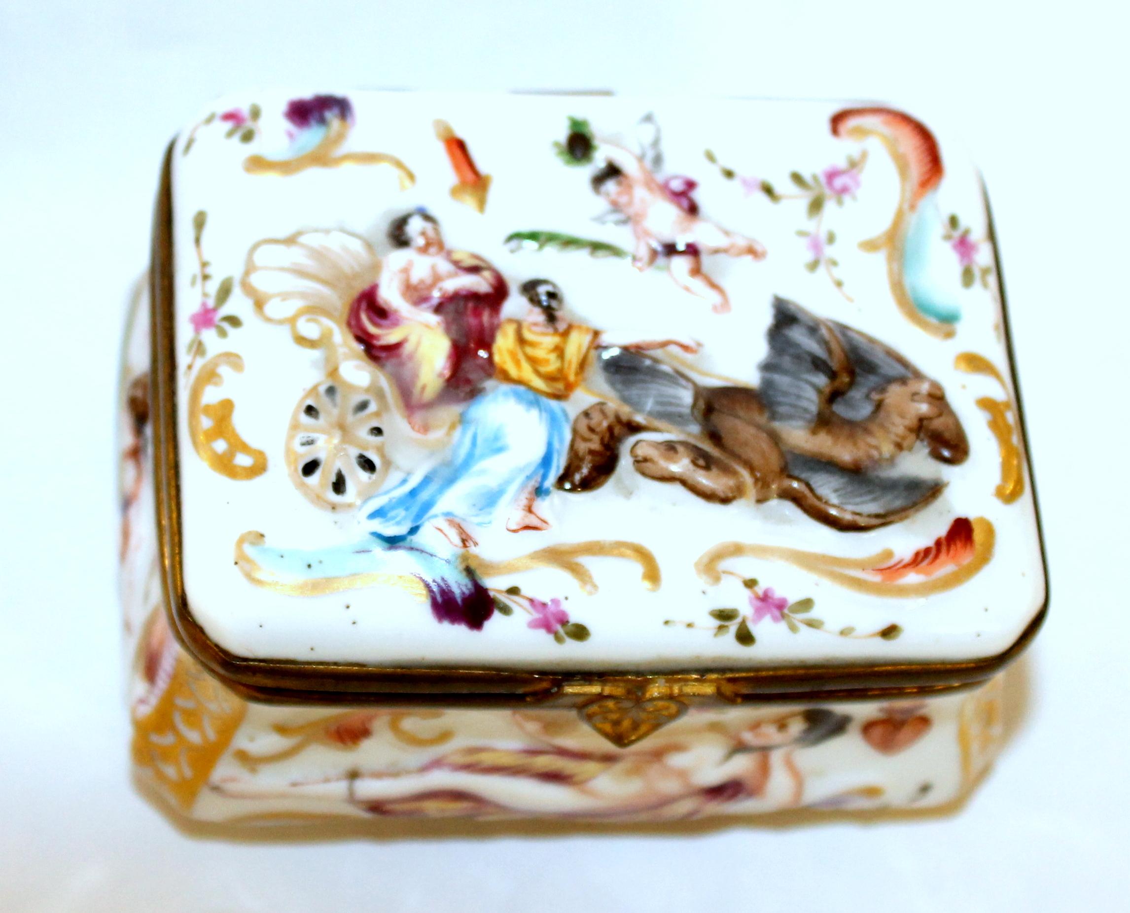 Rare antique Capodimonte type hand decorated hinged box with gorgeous original gilt interior and bas relief decoration on all sides including the bottom (quite unusual). No maker's marks found, but is in the classically decorated Capodimonte