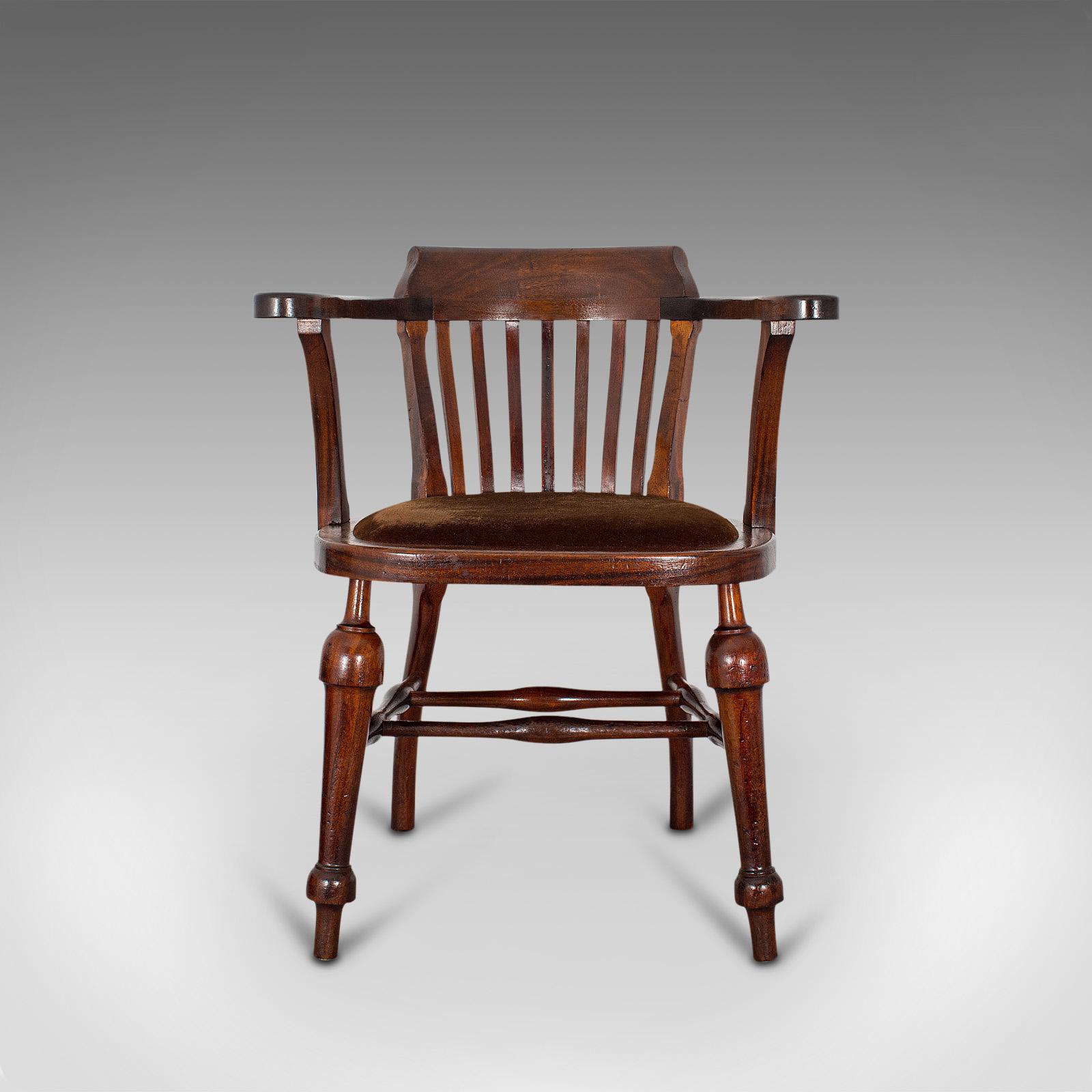 This is an antique captain's chair. An English, mahogany armchair with drop-in seat, dating to the Edwardian period, circa 1910.

An attractive armchair with serpentine form
Displaying a desirable aged patina
Mahogany offers fine color and grain