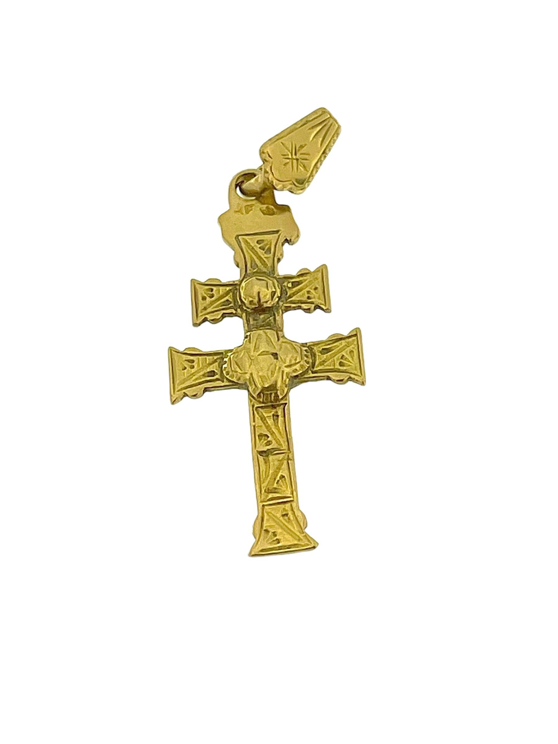 The Antique Caravaca Cross in 18 karat Yellow Gold is a magnificent piece of religious jewelry that carries rich history and symbolism. Originating from the Spanish town of Caravaca, this cross is revered for its unique double-sided design and its