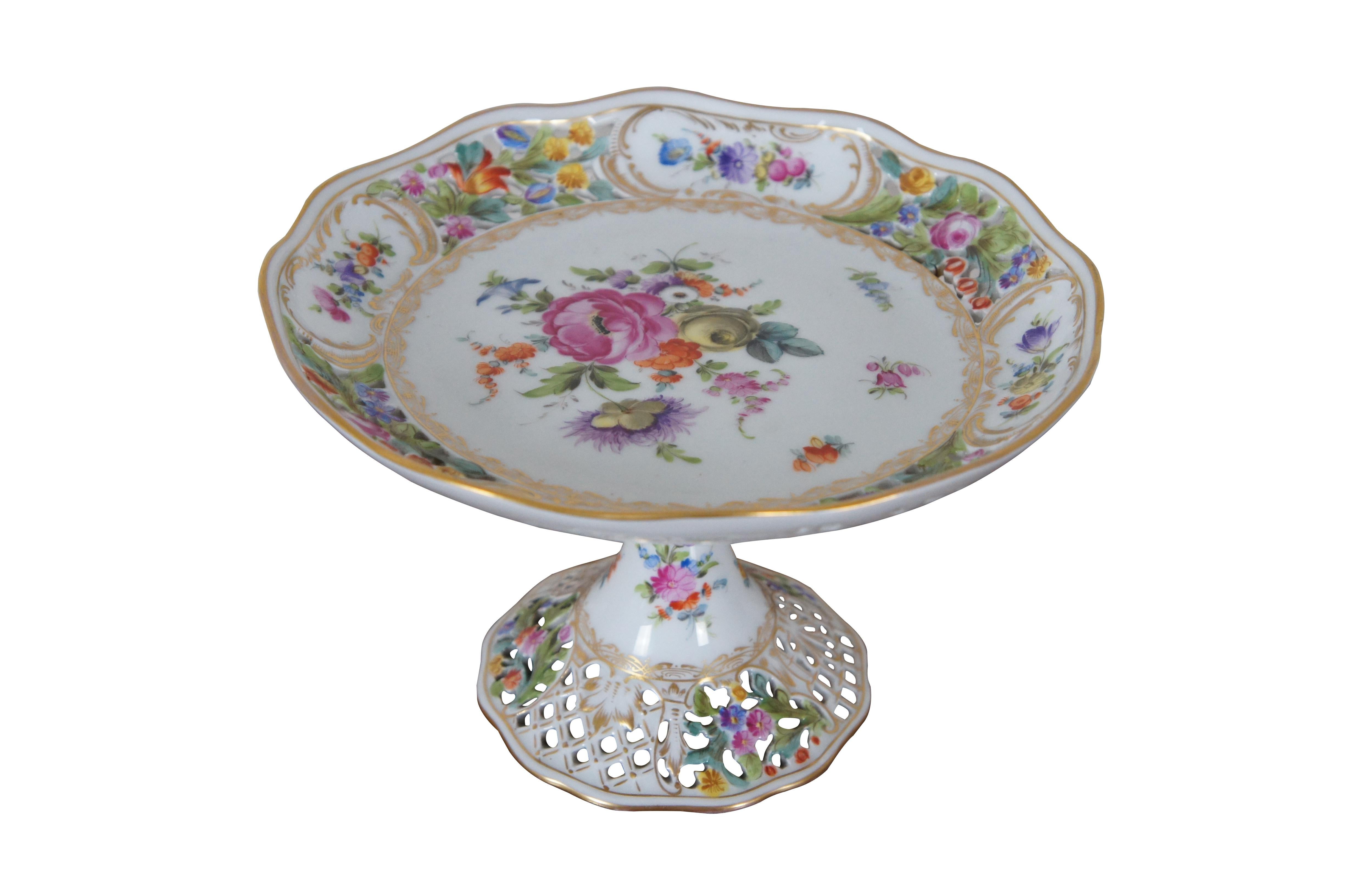 Antique Carl Thieme German Dresden centerpiece serving compote.  Made of porcelain featuring footed pedestal base and reticulated / pierced scalloped shallow bowl or cake plate with floral design.  Circa 1902-1920.

The Sächsische