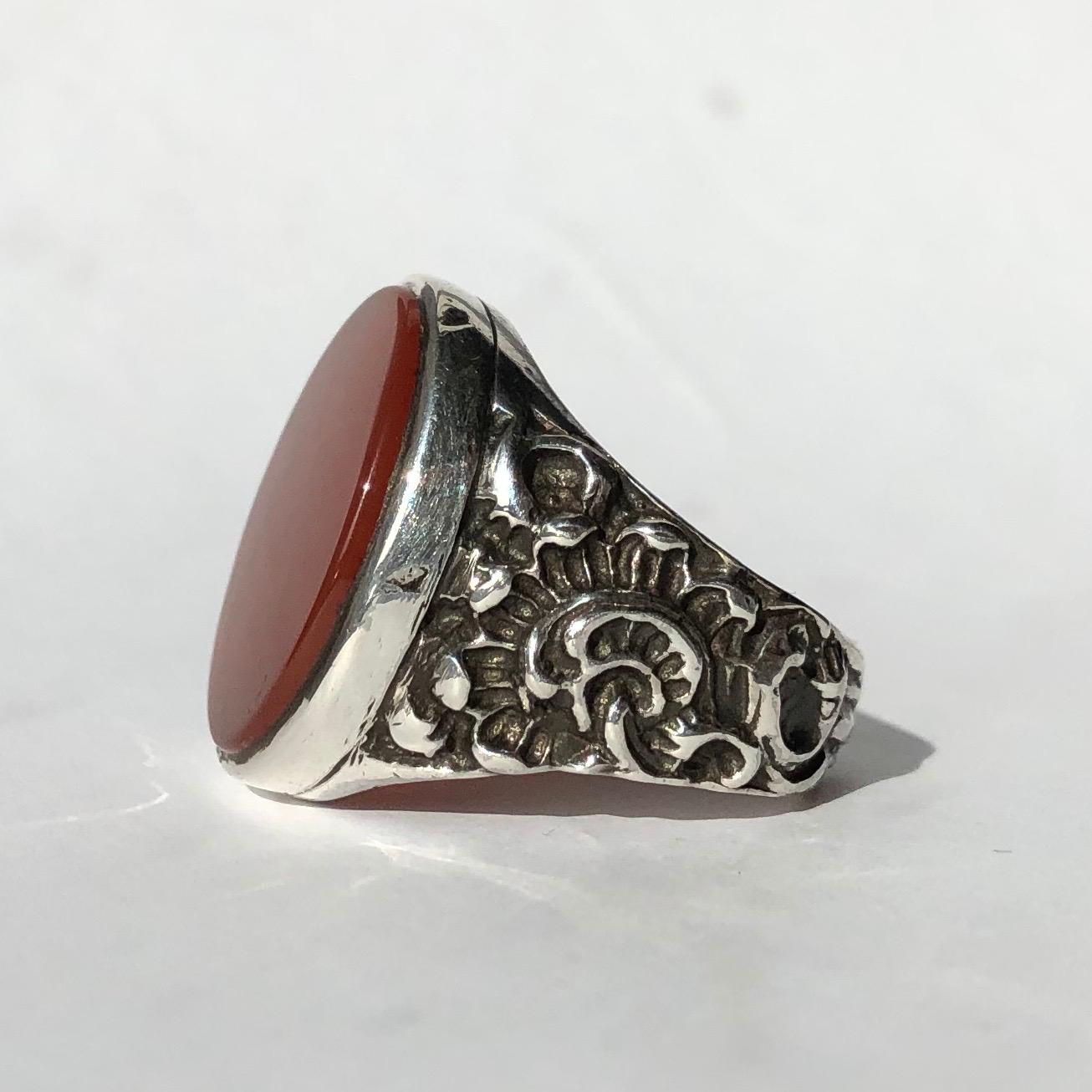 The chunkiness of the moulded silver and the large carnelian stone are a great match! The stone is set within a frame of silver and the shoulders have a floral design moulded into them. 

Ring Size: R 1/2 or 8 3/4
Stone Dimensions: 19x15mm

Weight: