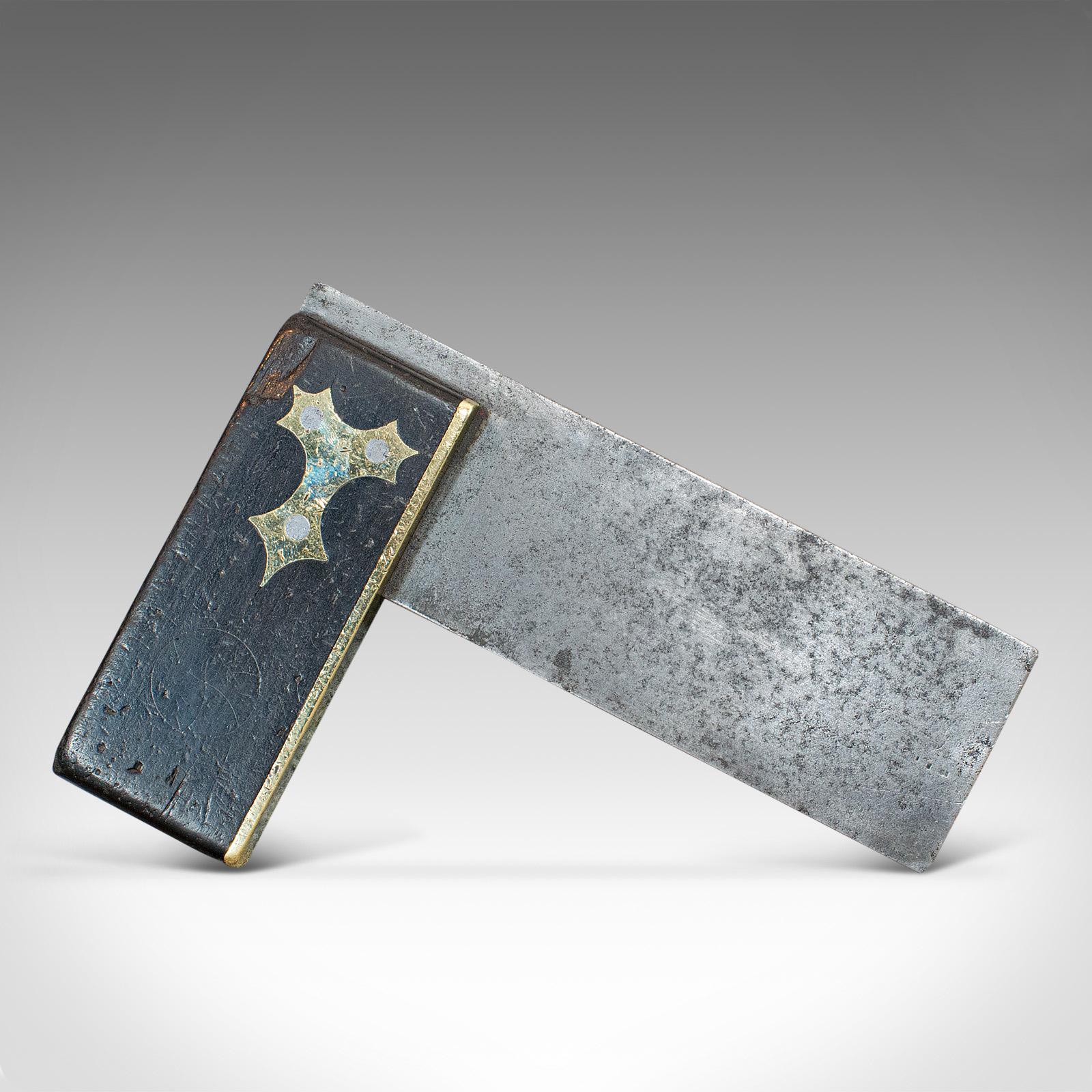 This is an antique carpenter's square. A Scottish, ebony and brass tool, dating to the late Victorian period, circa 1900.

Nicely decorated set square
Displays a desirable aged patina
Ebony handle capped with brass

Attractive tri-form brass