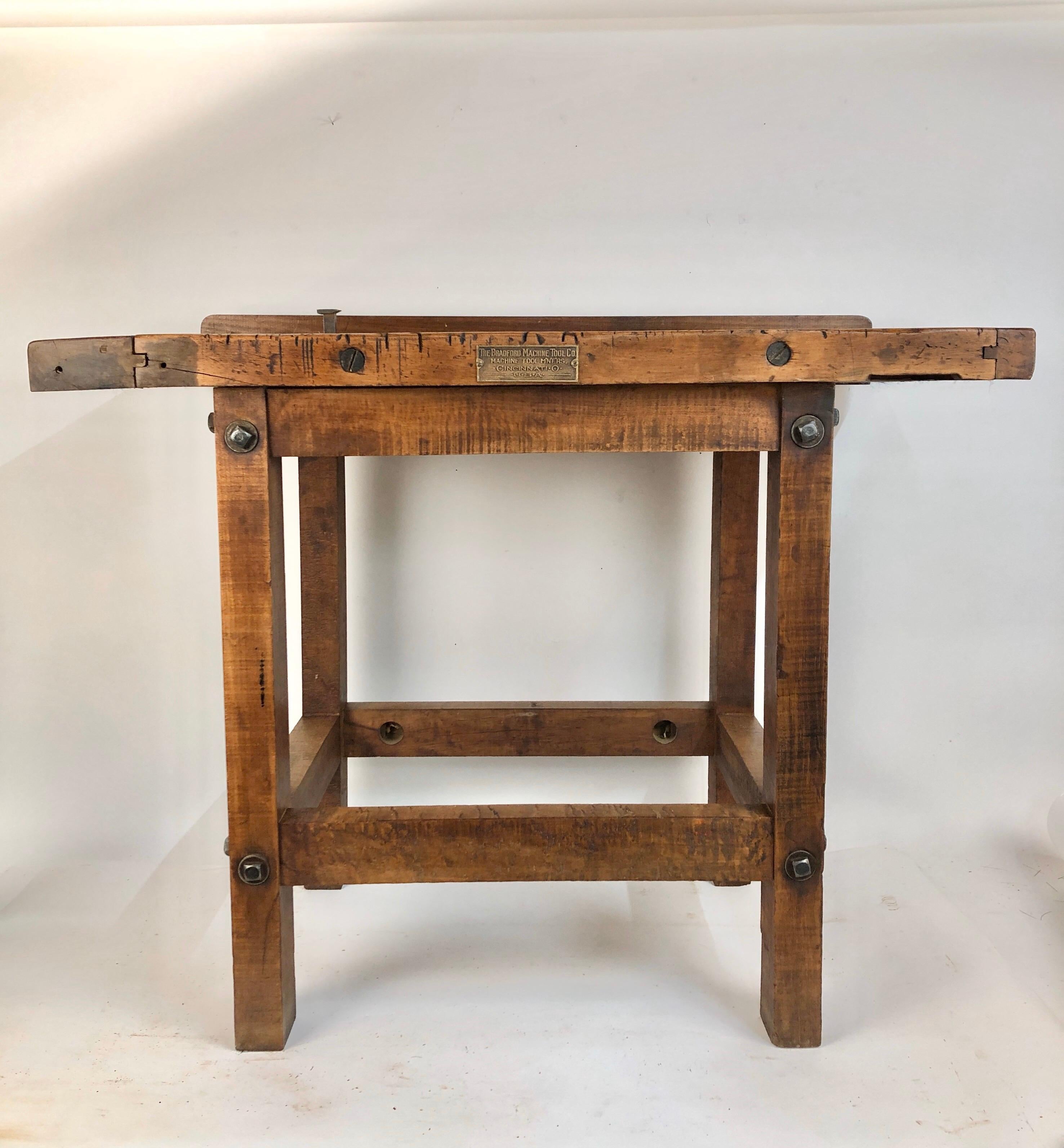 Rare small antique wood carpenters work table made by the Bradford Machine Tool Co. Cincinnati Ohio. Works perfect as a bar, kitchen island, server or entrance table. Beautiful untouched rich golden brown color with dark graining lines. Solid and